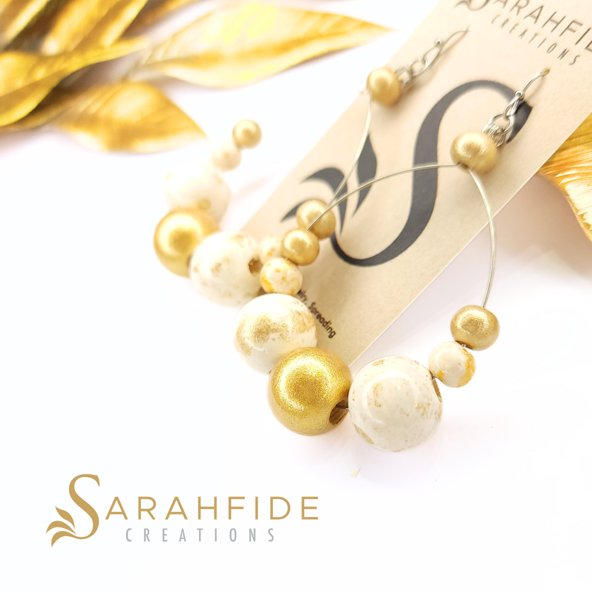 Gold Lux Large Round Drop Earrings on a Sarahfide card, warm white and gold hand-painted wood beads