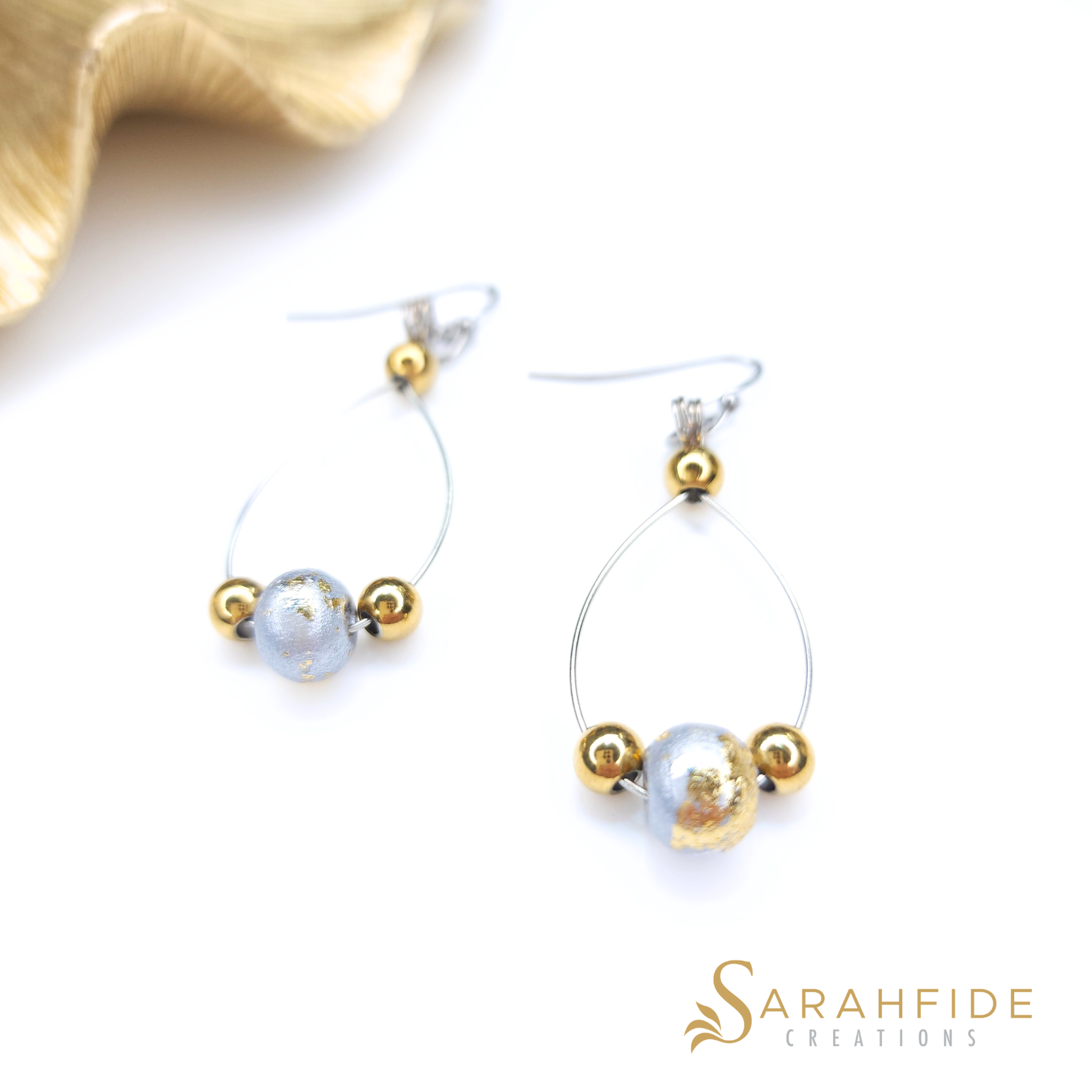 Silver sparkly drop earrings laid flat