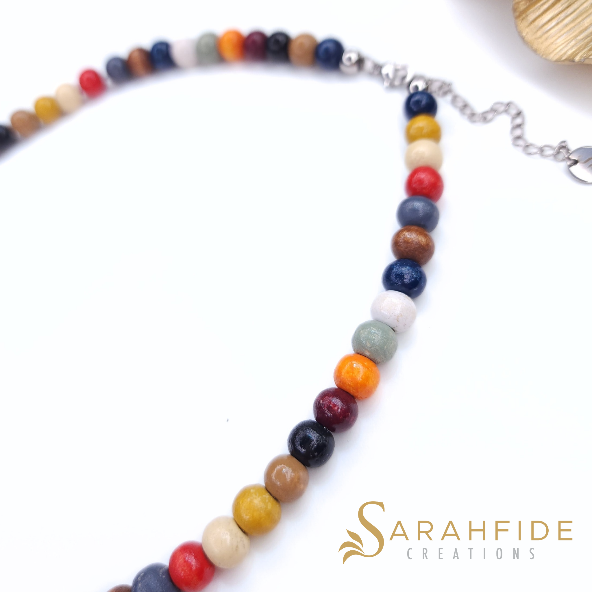 Close-up of red, burgundy and orange beaded necklace