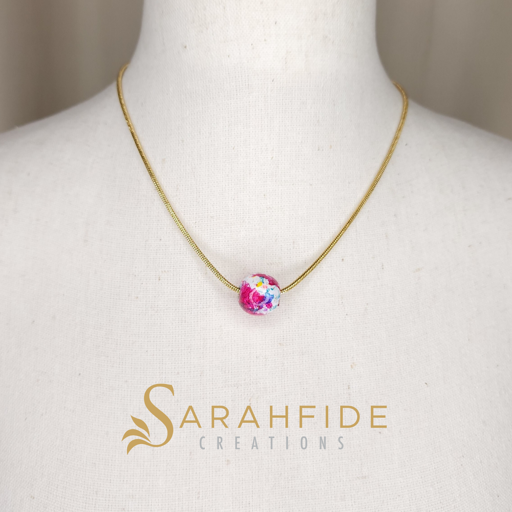 Unleash your bold and unique style with our exquisite hand-painted bead pendant necklace featuring a sleek snake chain and hand painted bead.

Sarah painted this with her number one selling paint design (her signature paint design) Garden Goddess.

T