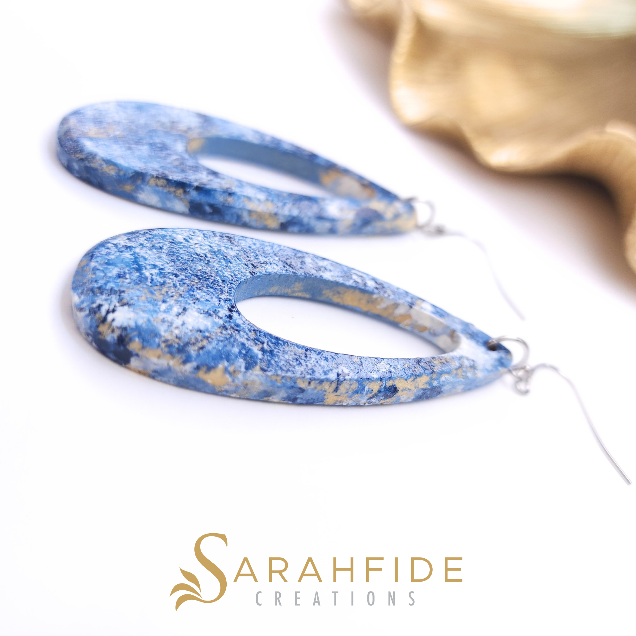 Denim blue drop earrings laid flat