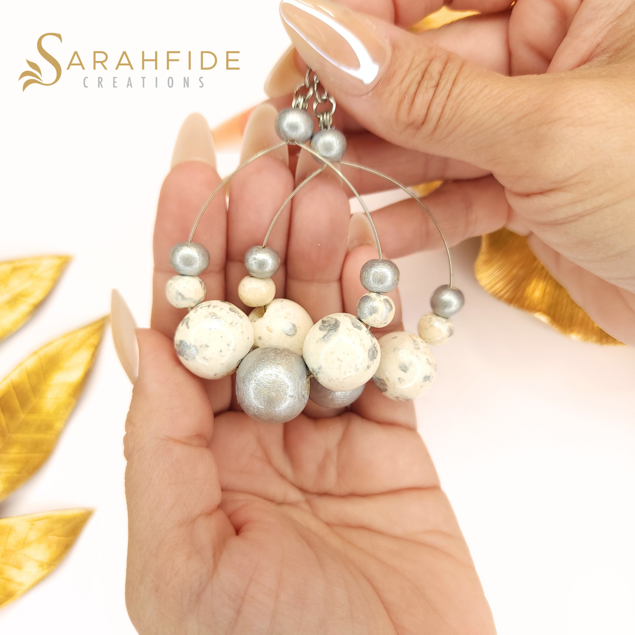 Silver Lux Large Round Drop Earrings held in a hand