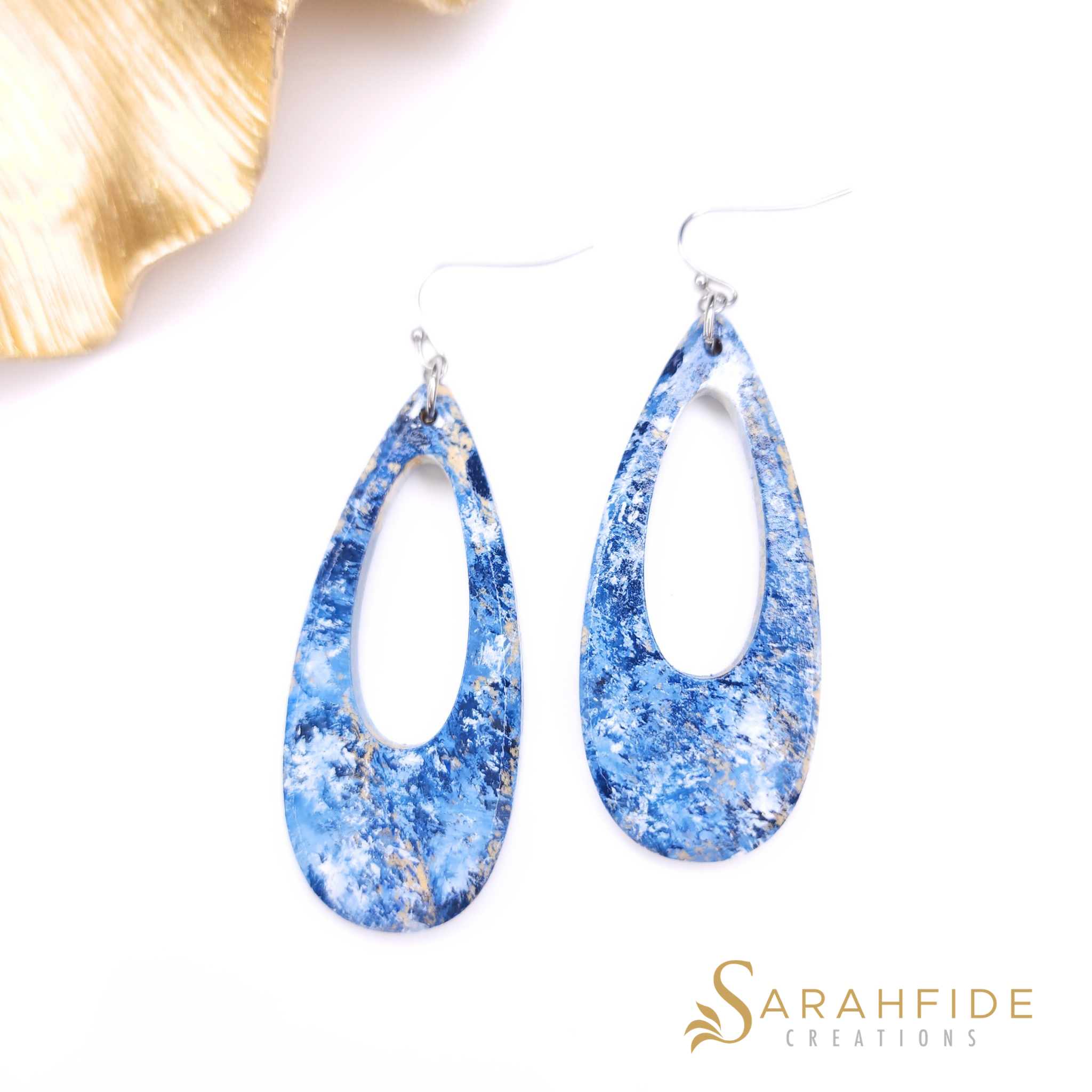 Denim blue drop earrings laid flat