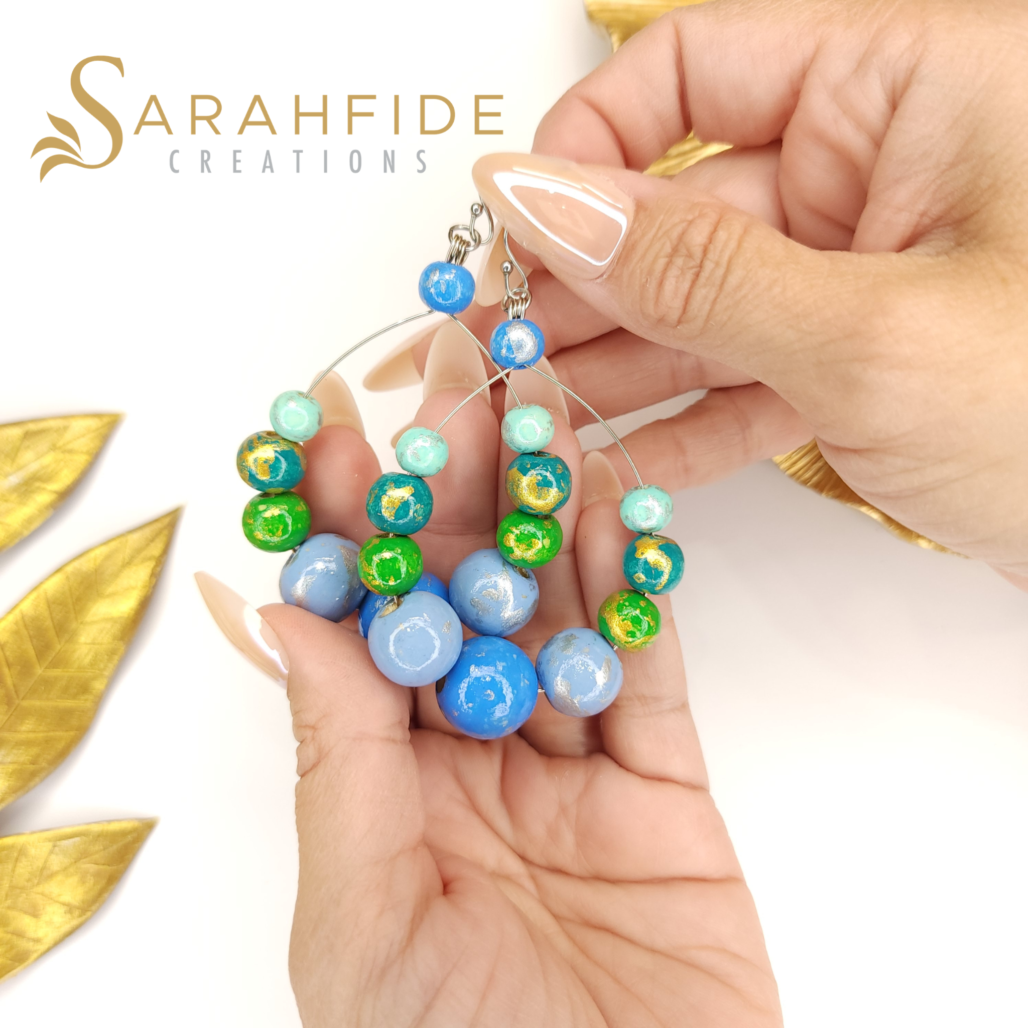 Blue Color Pop Large Round Drop Earrings held in a hand