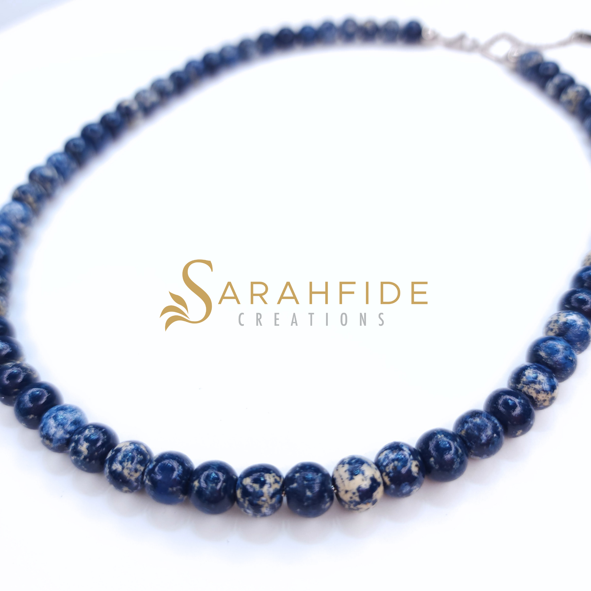 Denim blue beaded necklace laid flat