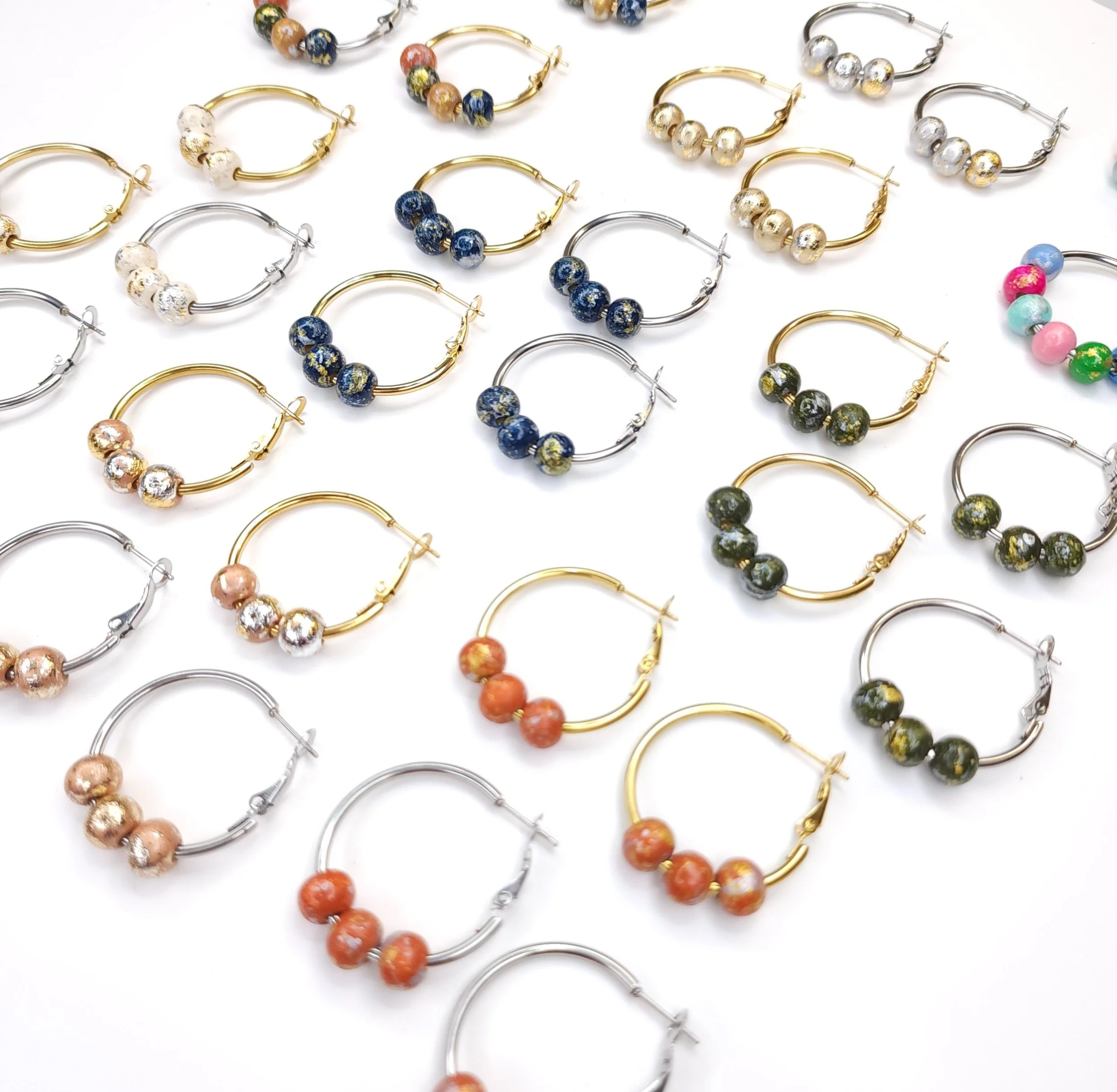 Gold and silver hoop earrings with three hand-painted wood beads in navy, green, orange, rose gold and gold