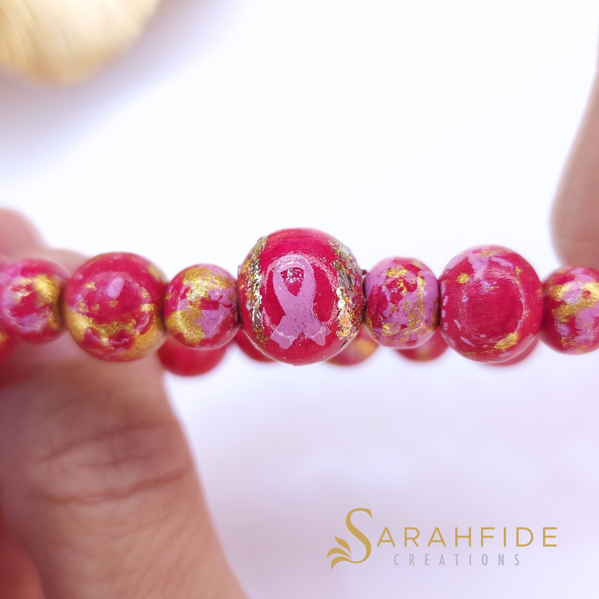 Close up of the pink ribbon bead on the Breast Cancer Awareness Bracelet
