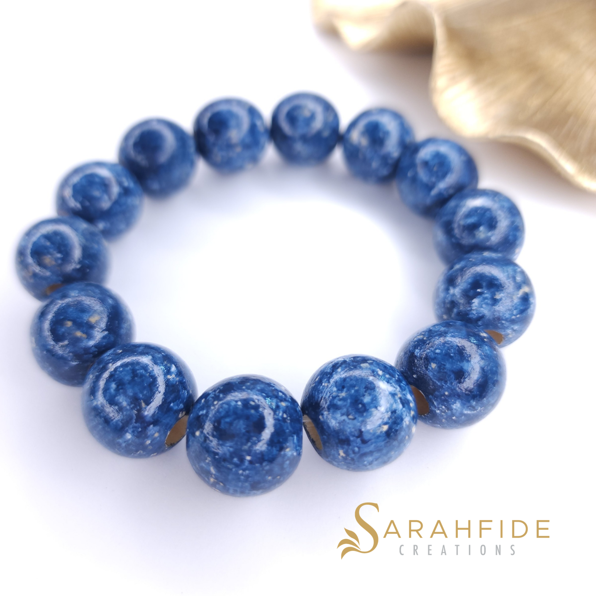 Denim Ritzy Bracelet laid flat, hand-painted denim blue wood bead stretch bracelet