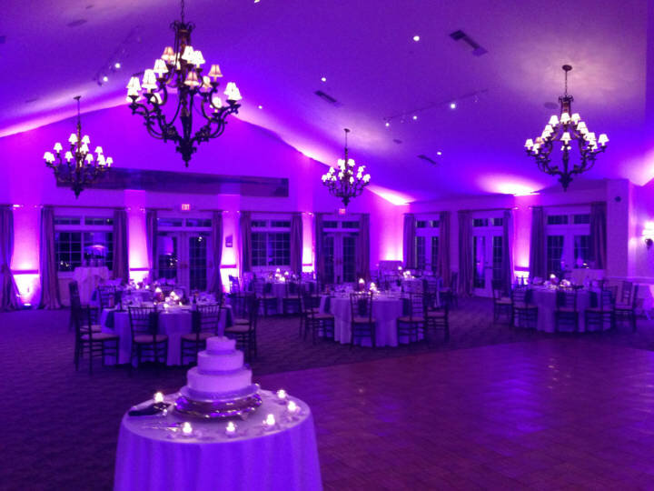 Purple uplighting filling an event ballroom