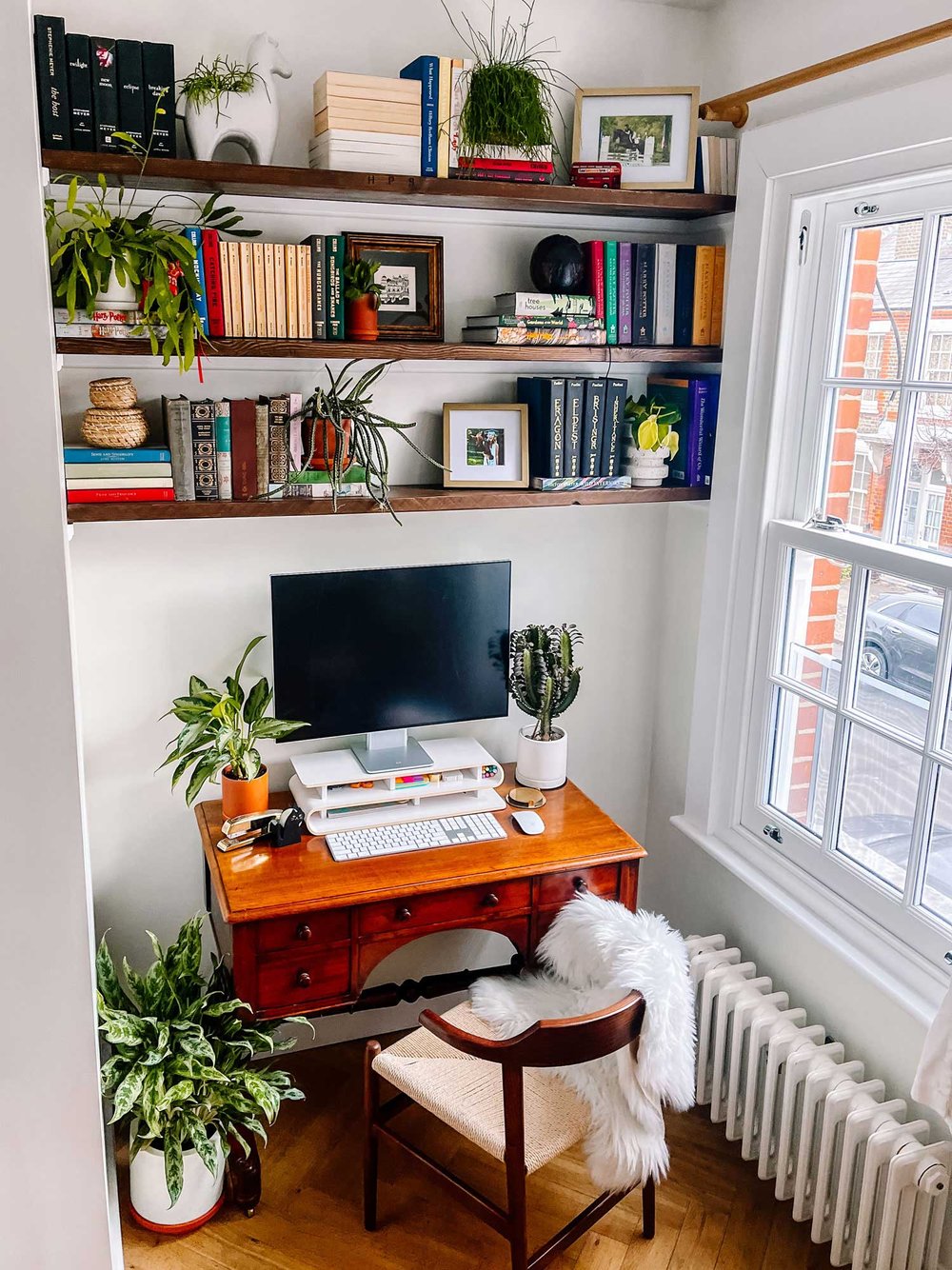 Home office nook with shelves and antique desk