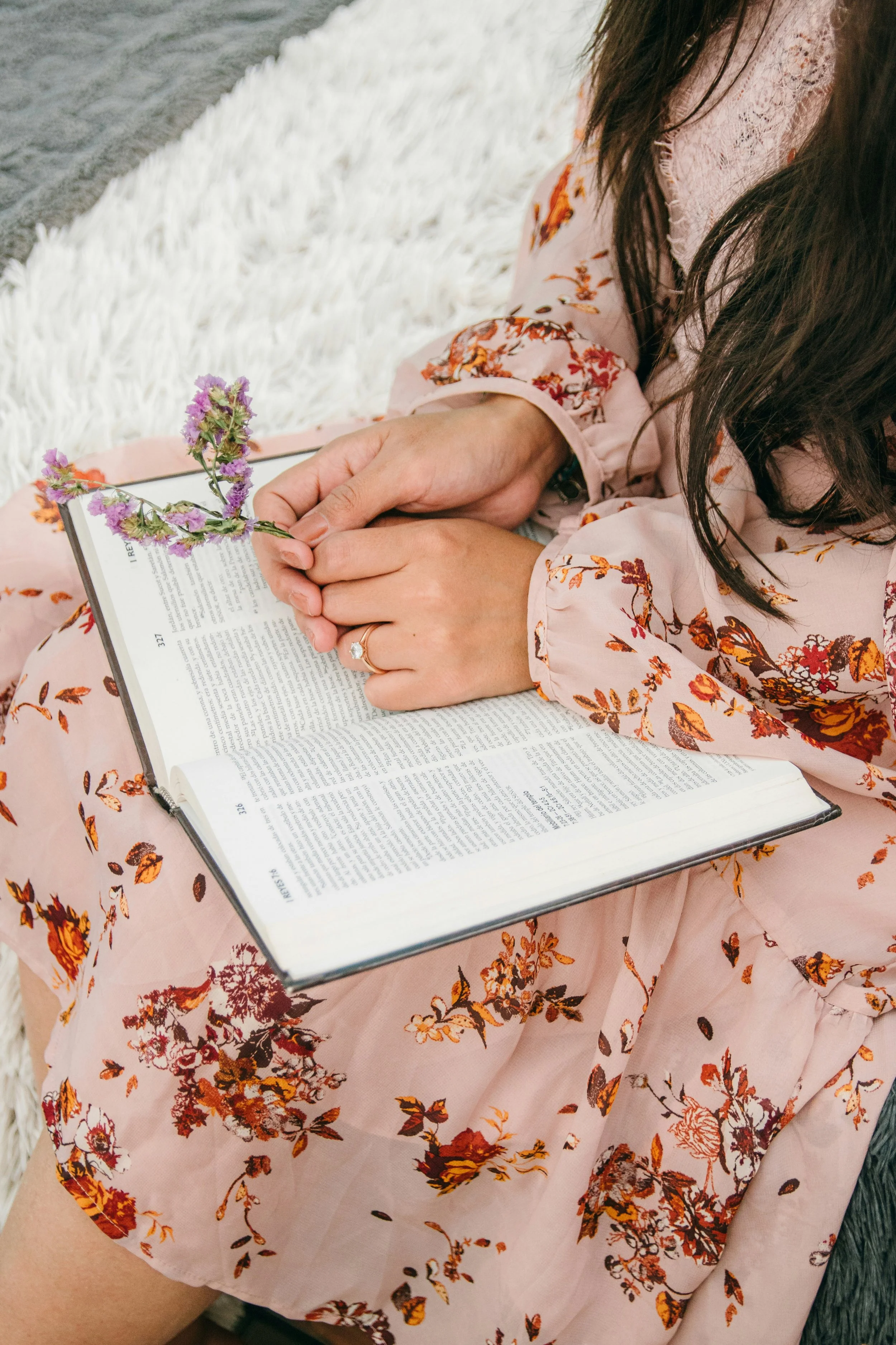 A white woman in a dress reading the bible