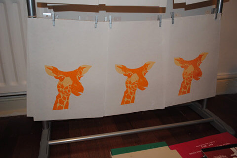 Layer 2 reduction linocut method hanging on drying rack in a home printmaking studio.jpg