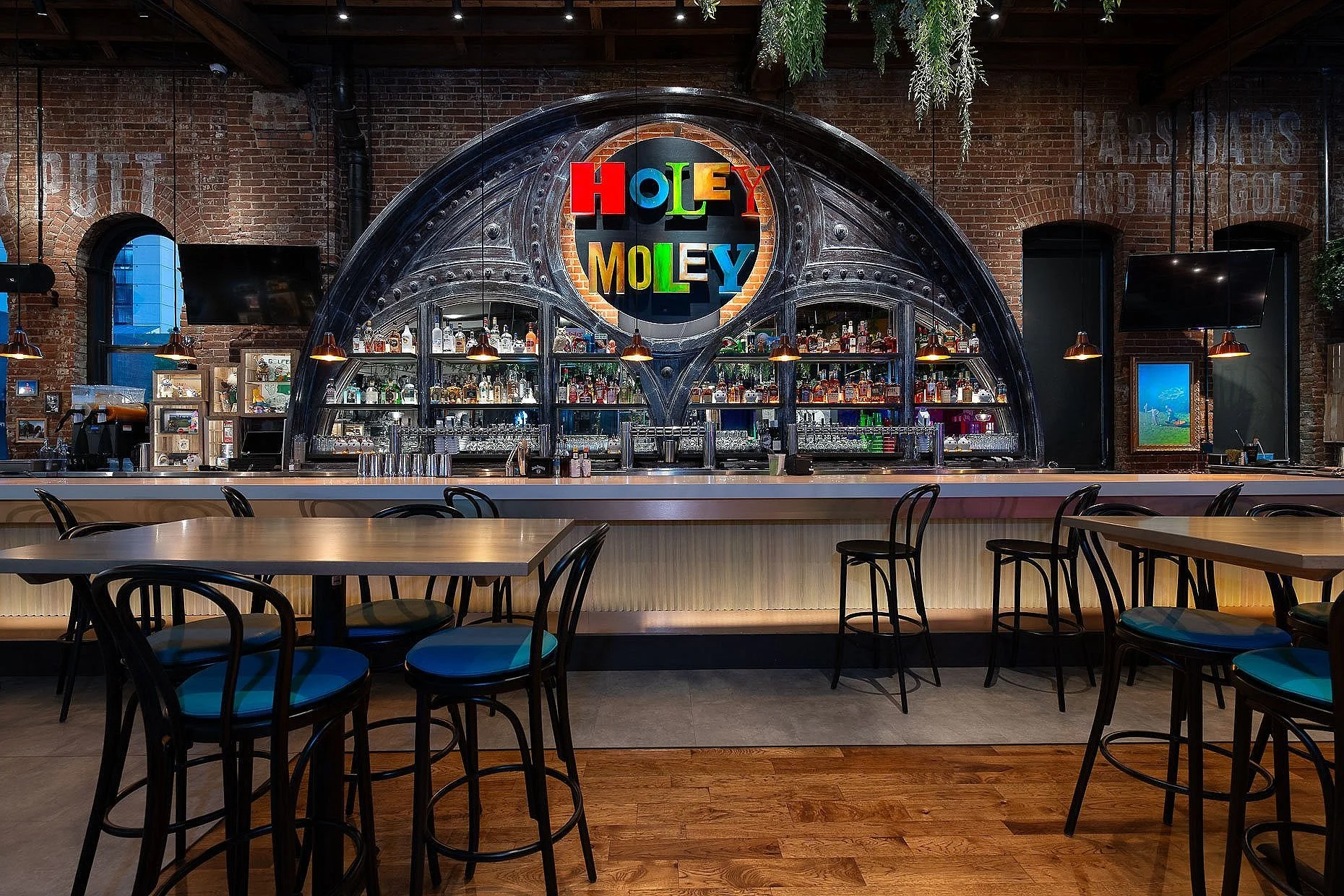 Indoor put-put golf venue with gorgeous antique bar and open seating.