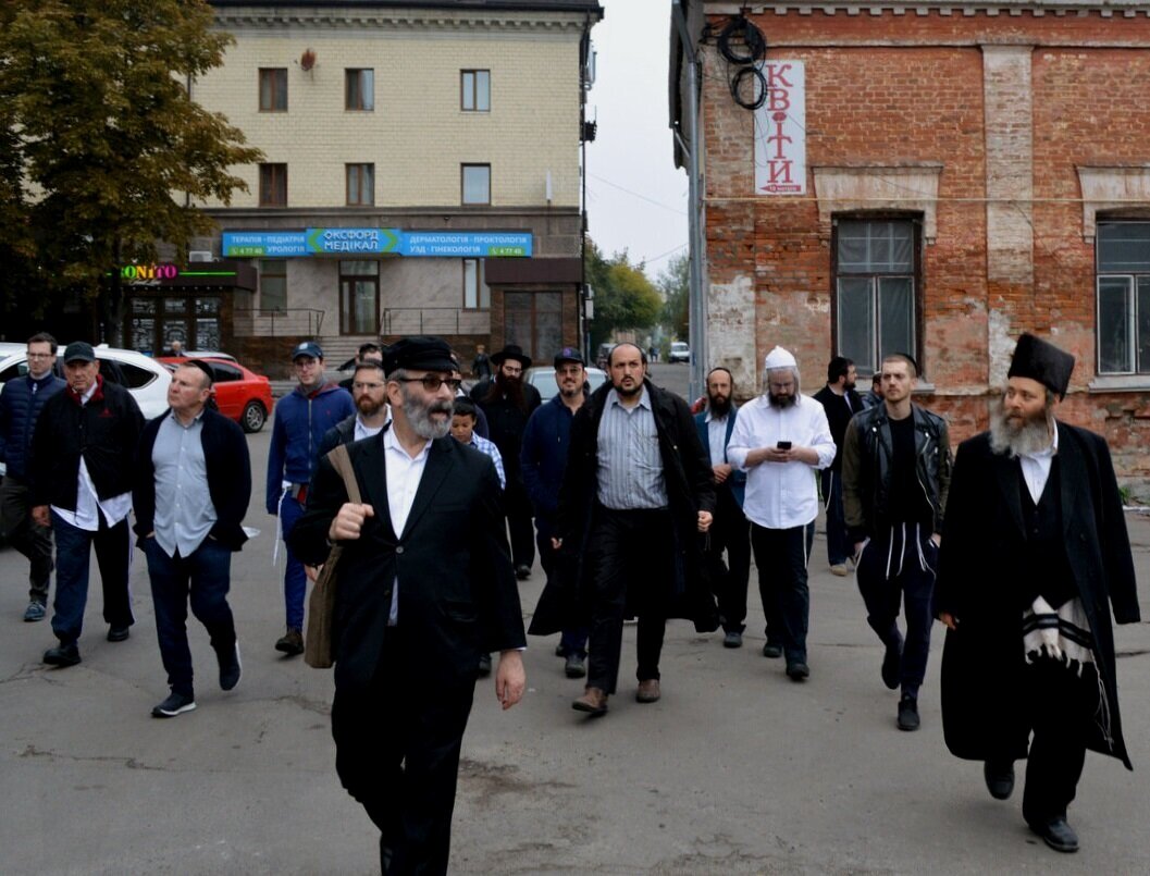 Rabbi Gil Bashe (front left, with satchel) leading pilgrims through Uman, Ukraine. Photo — Shai Afsai