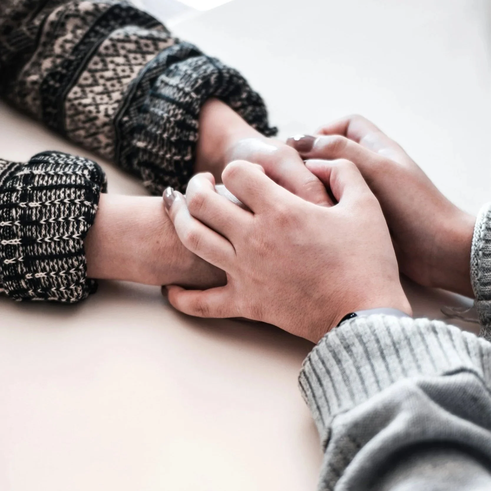 Two people holding hands while strengthening communication and emotional connection through therapy in Durham, NC.