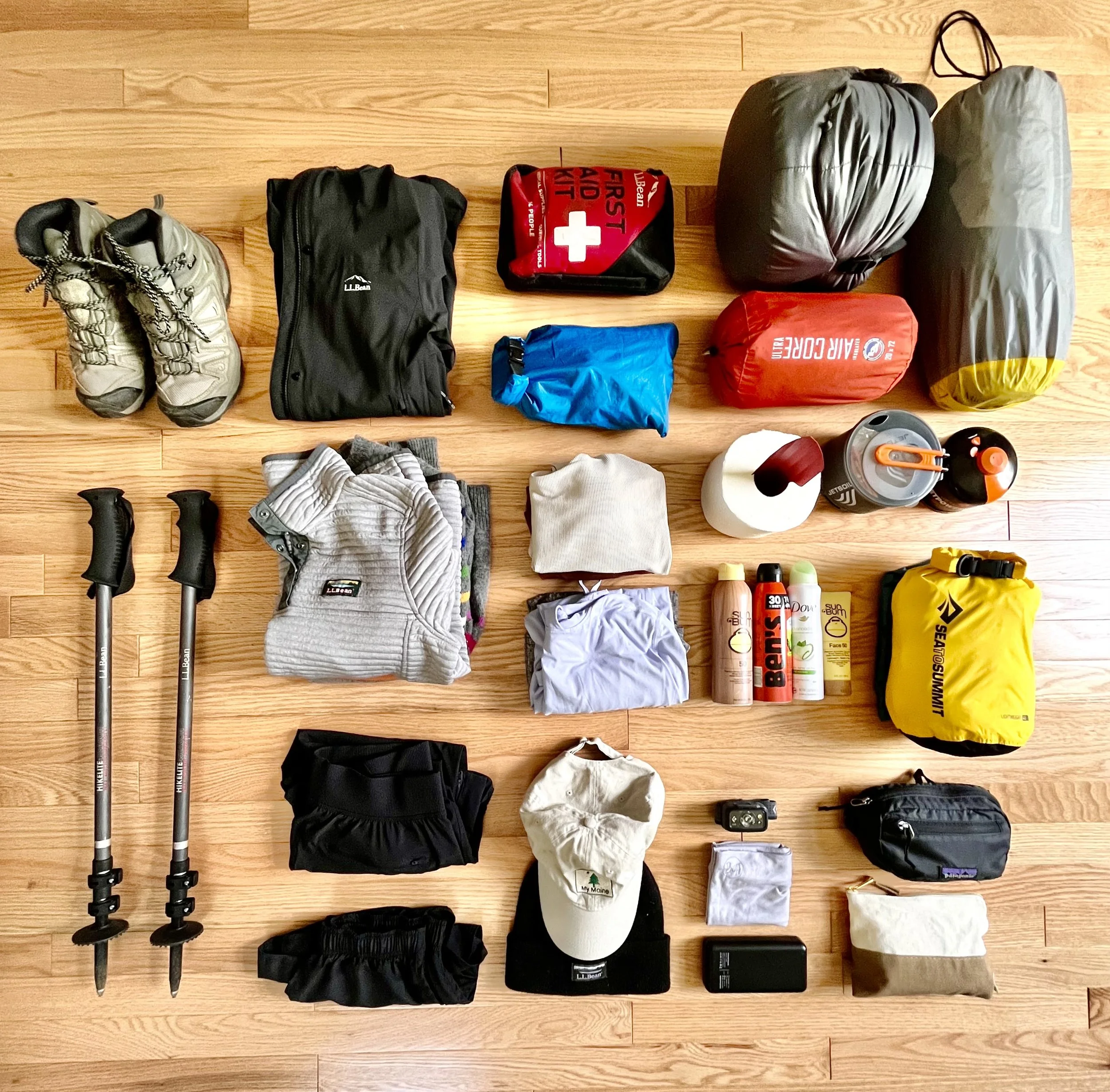 Hiking gear in piles on the floor