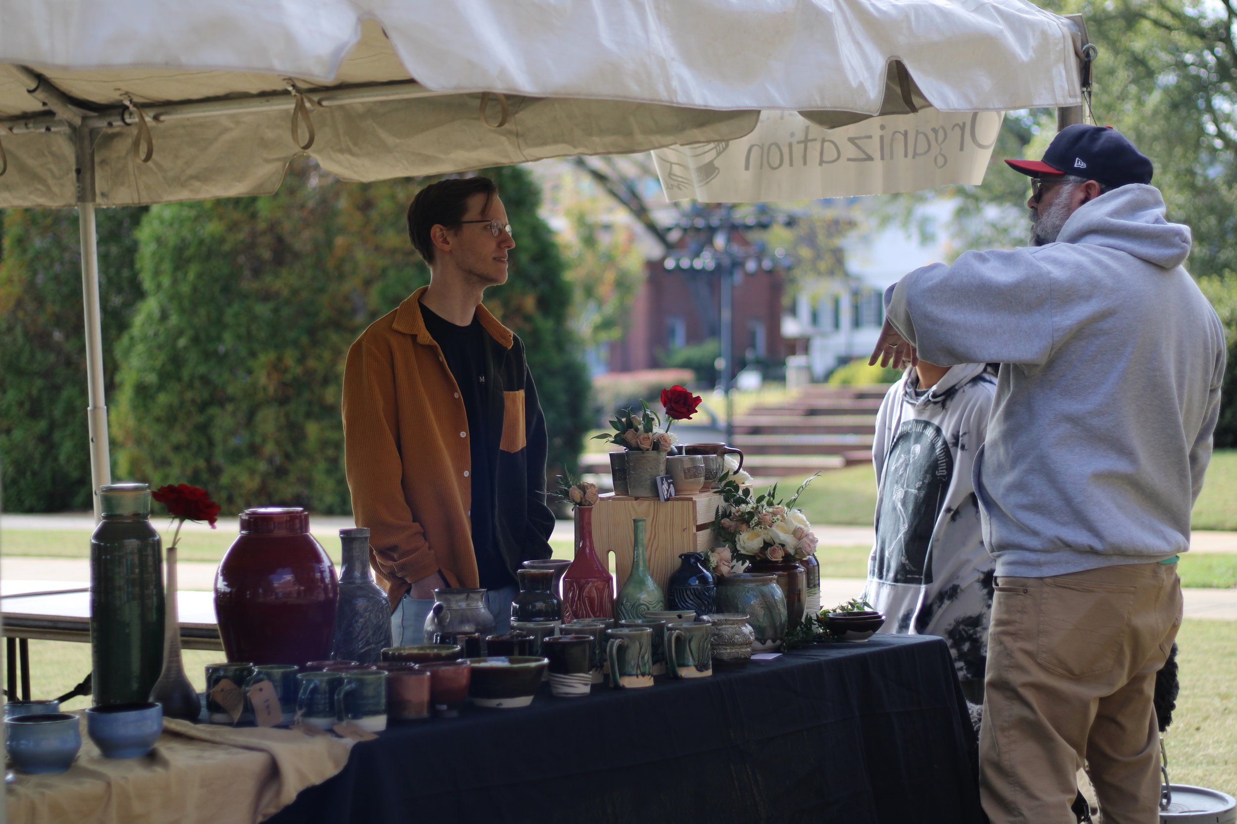  Potter Henry McCarter speaks with visitors at his table in the pottery sale Monday, Nov. 14. 