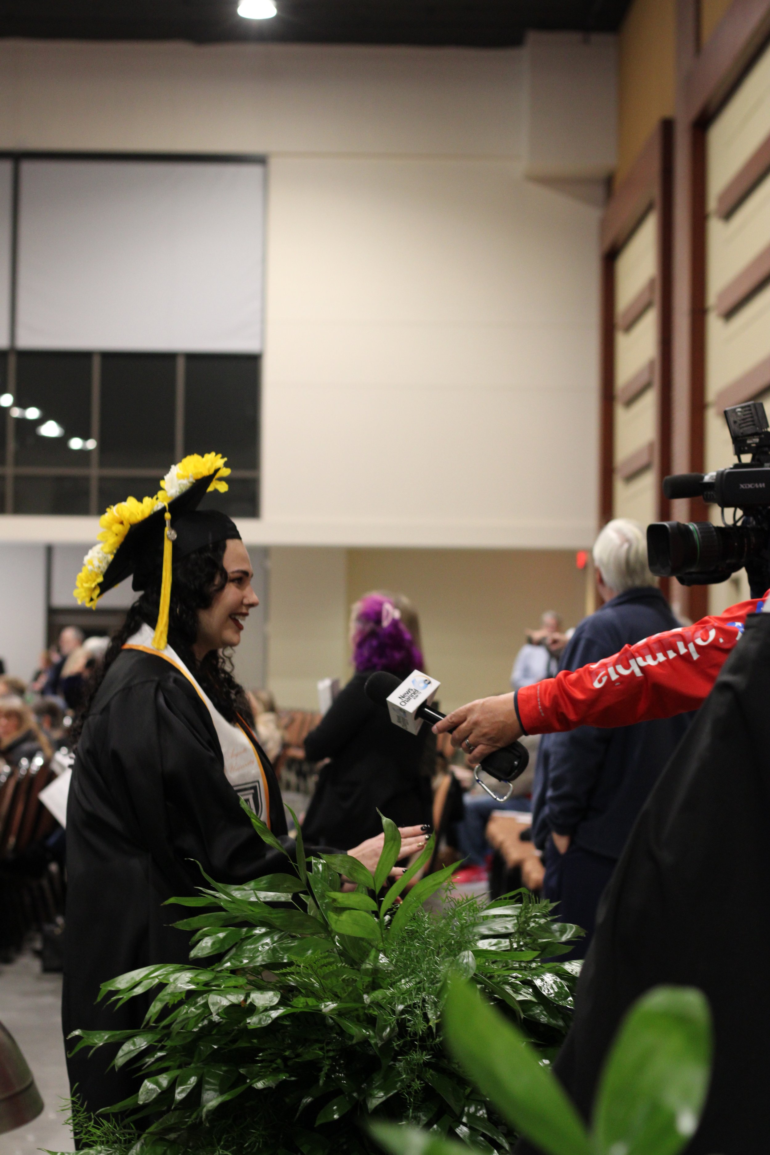  Graduates speak with local media.  (photo by Rakiyah Lenon)  