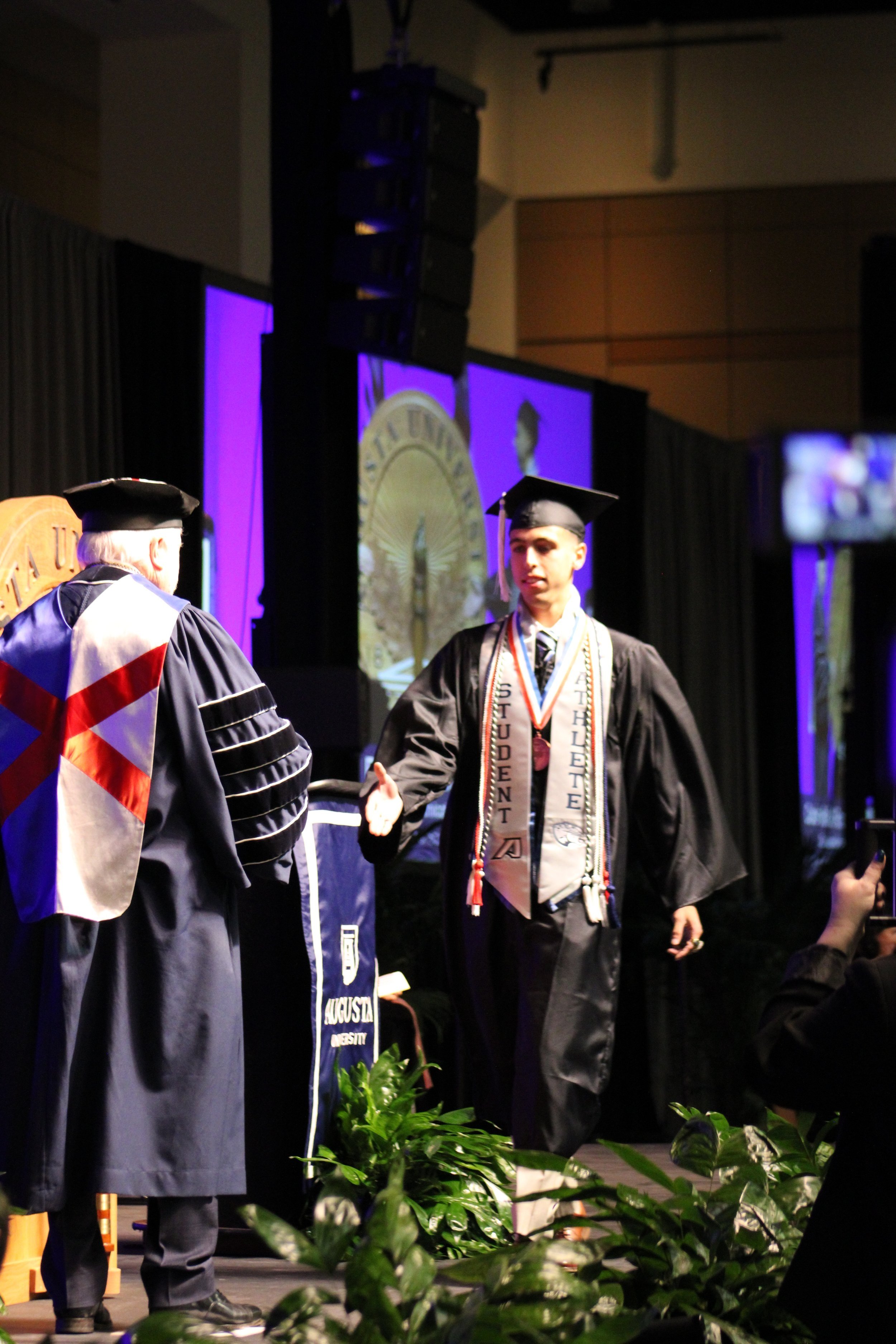  Student-athlete Carlos Rodriguez walks the stage.  (photo by Rakiyah Lenon)  