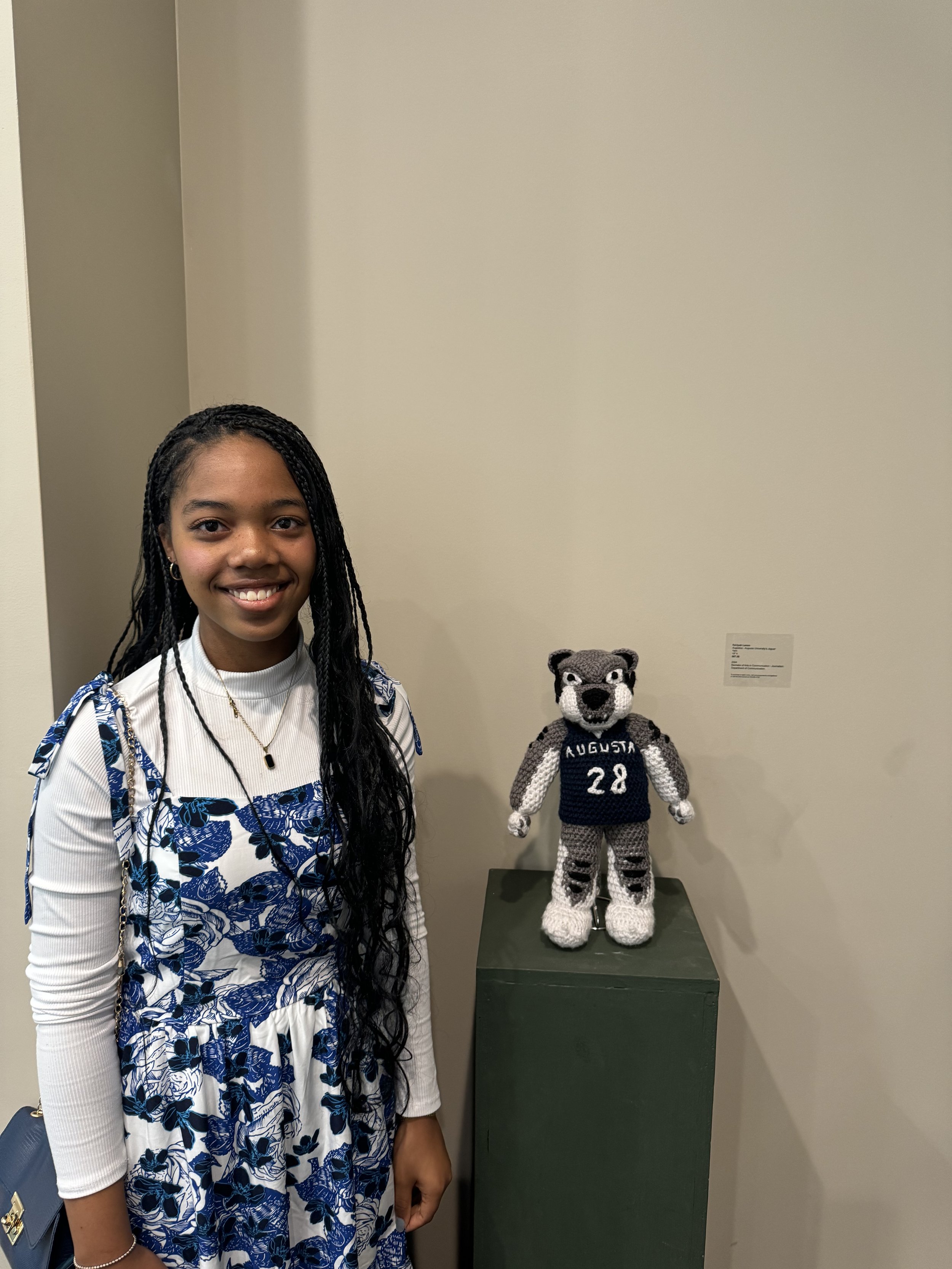 Rakiyah Lenon, our Editor in Cheif next to her work.