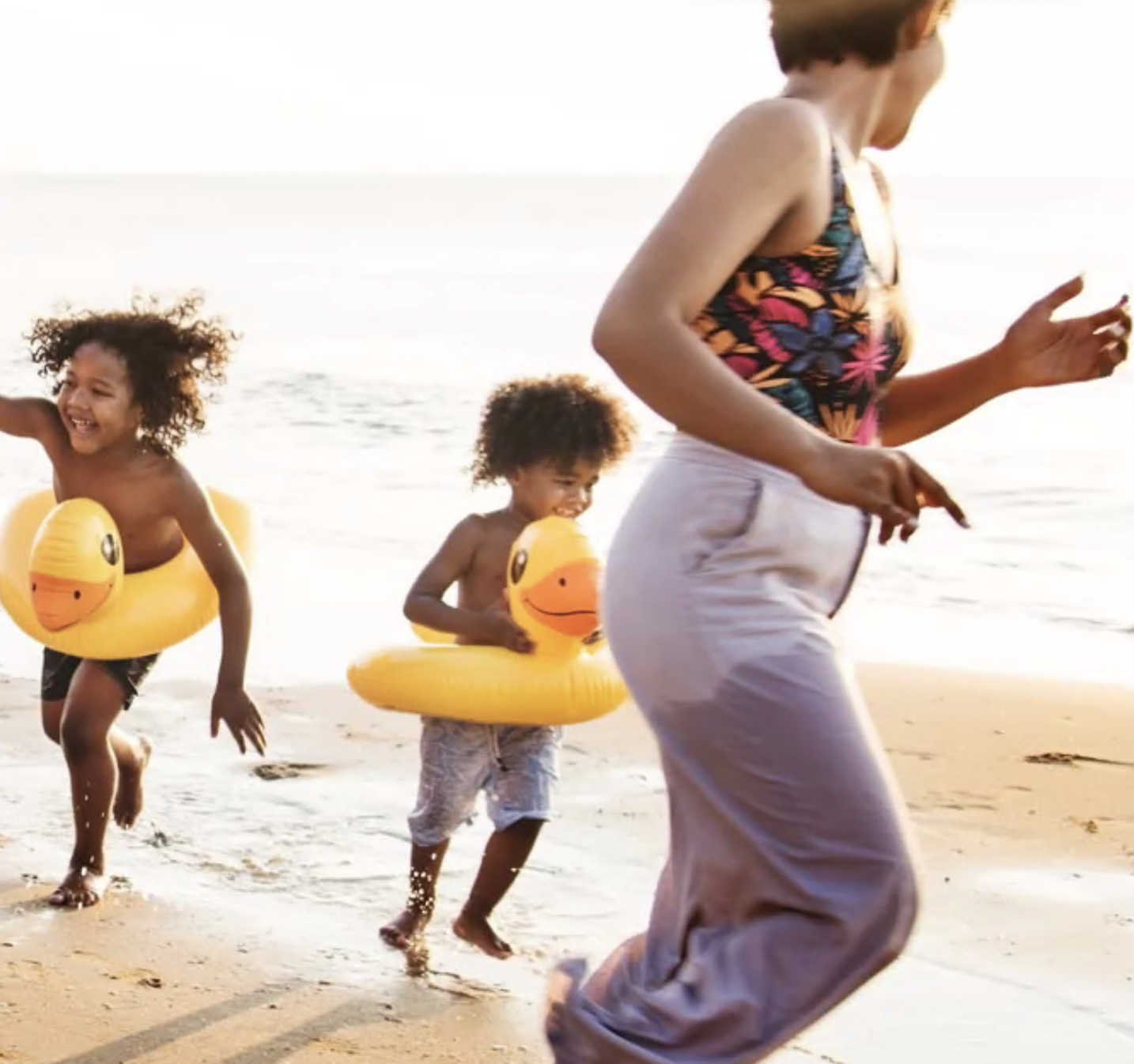 Black single mum with twins running on beach - August 7, 2023.png