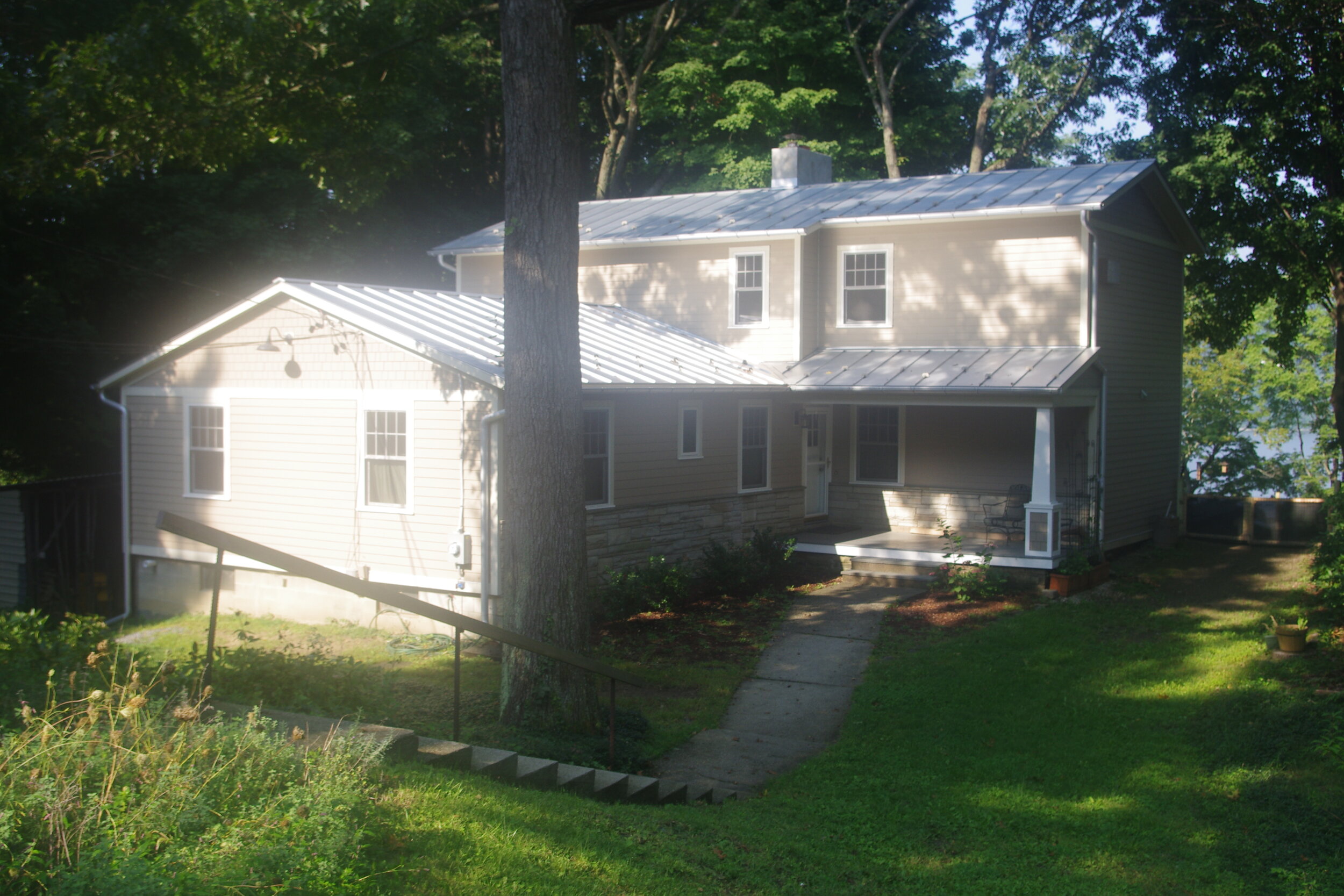 Same shape and size, but new roofing, siding, windows and covered porch