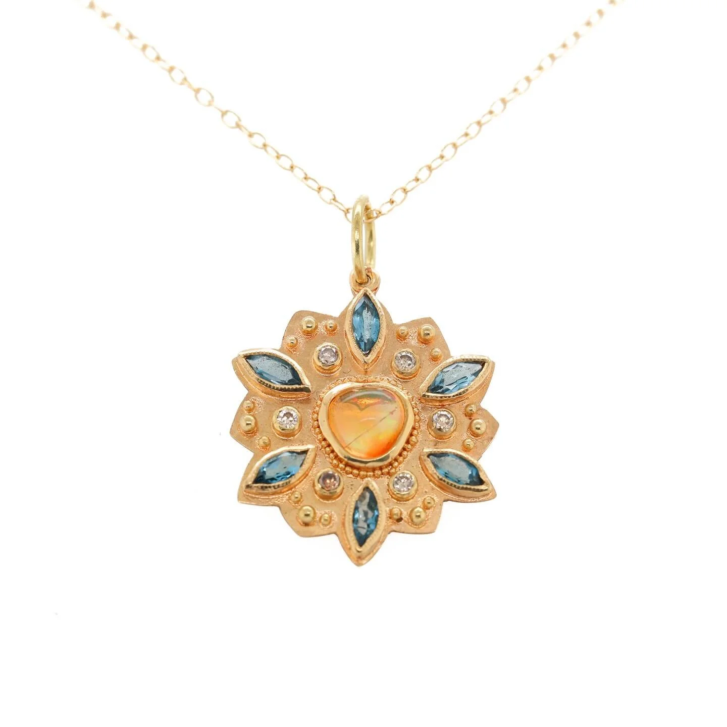 Rainbow Fire Opal Mandala Pendant. Made with 18k gold, rainbow fire opal, blue topaz and rose-cut diamonds.

This pendant can be found on my website or you can DM me here for details.

#artisanjeweler #artisanaljewelry #goldgranulation #oneofakindart