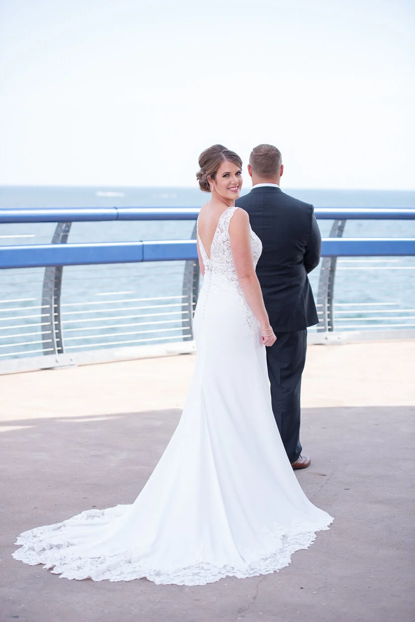 wedding-day-first-look-bride-looking-over-her-shoulder-about-to-surprise-groom