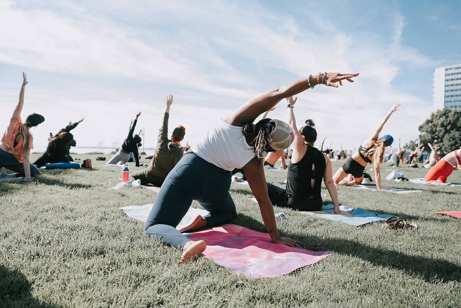 Beautiful black woman doing yoga in Long Beach at the Hustle & Play retreat