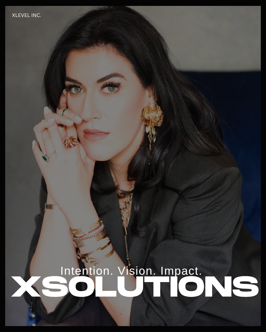 A woman with dark hair and striking eyes, wearing large gold earrings, multiple bracelets, and rings, poses with her hand near her face, against a neutral background. The overlay text includes 'XSolutons' and slogans about intention, vision, and impact.