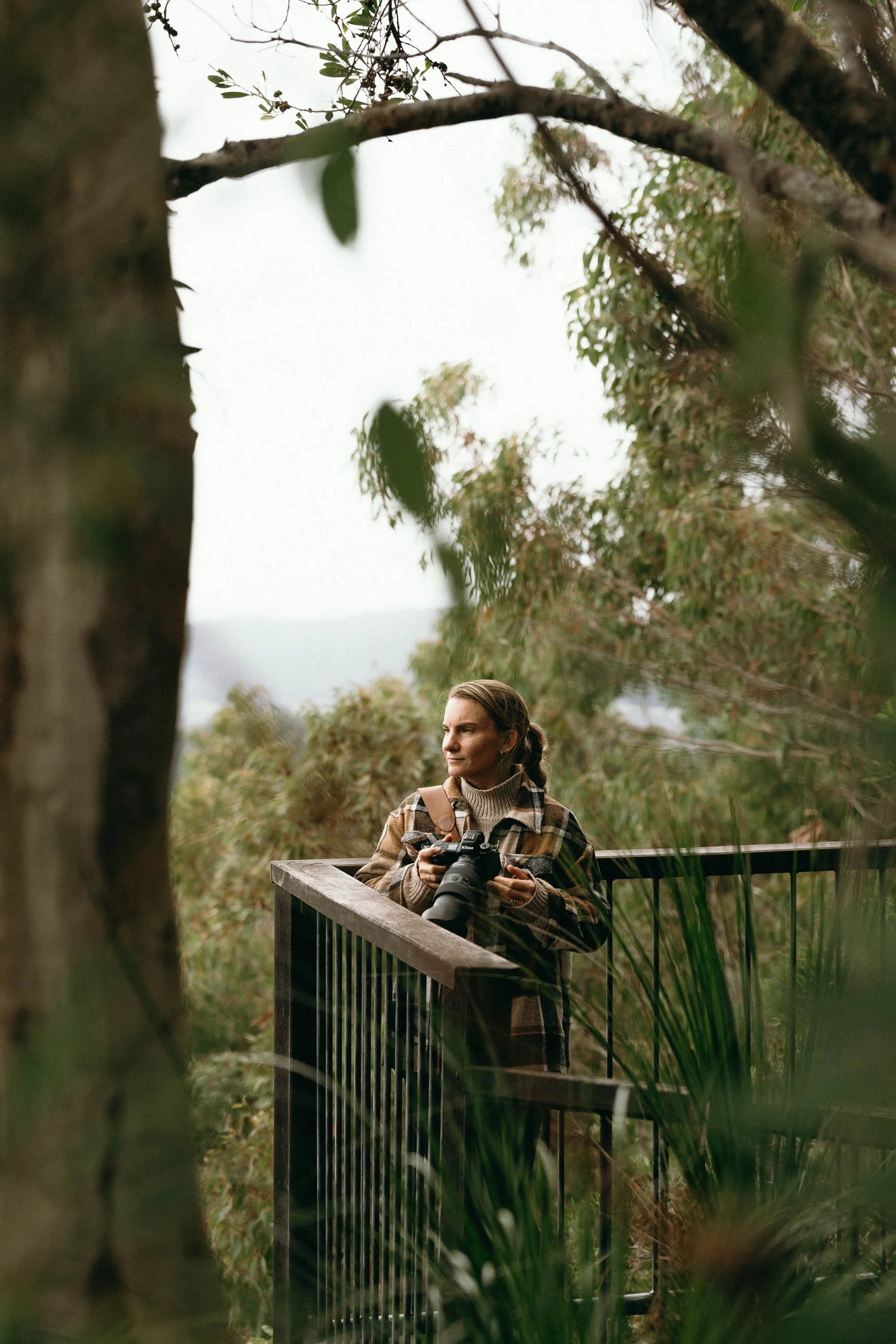 Photographer outside in nature looking out at the view