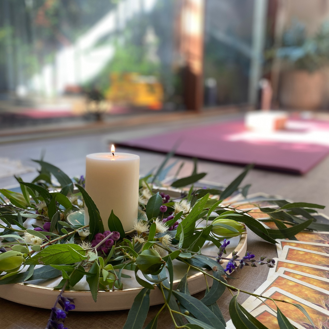 a candle next to a yoga mat