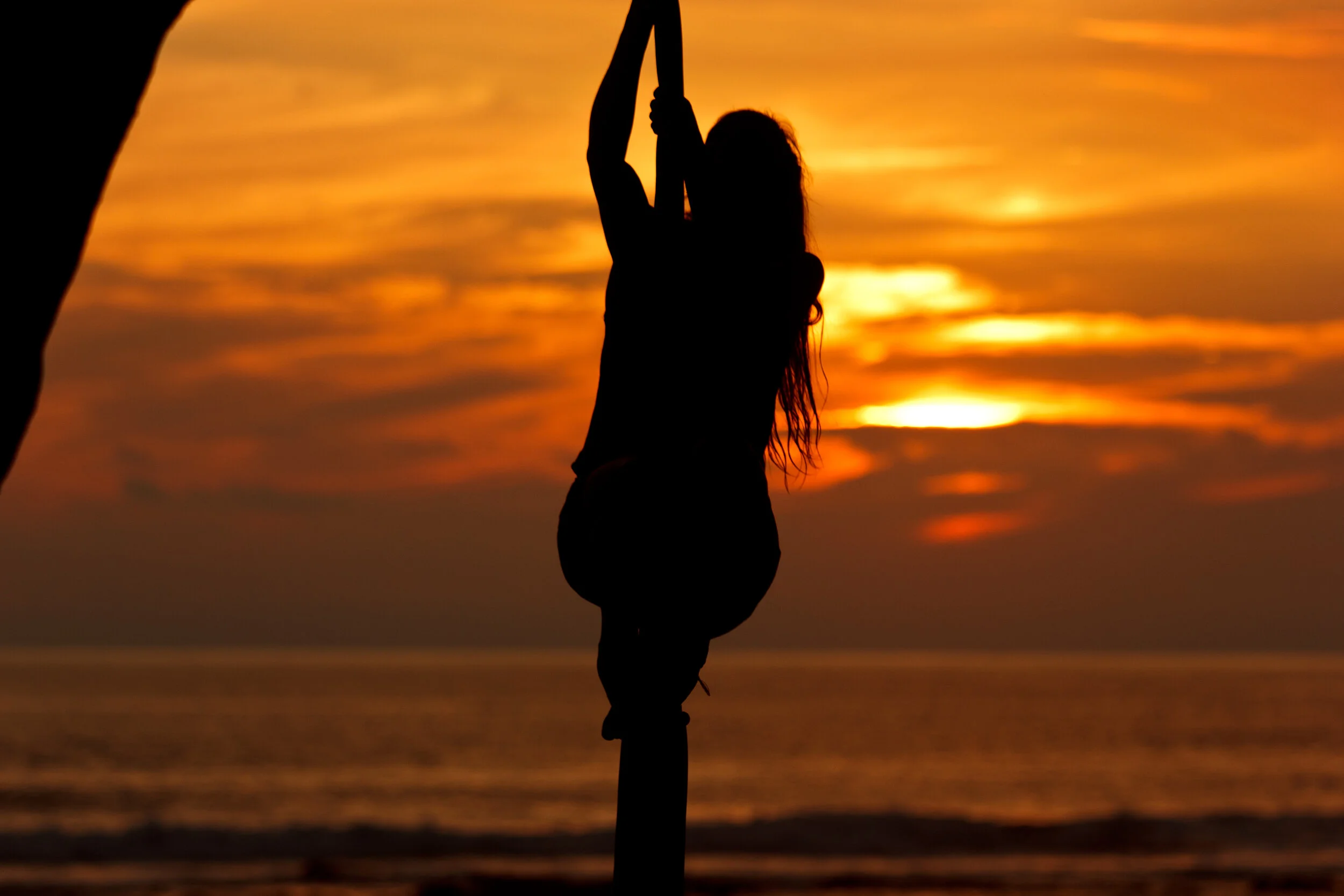 Women doing yoga in sunset