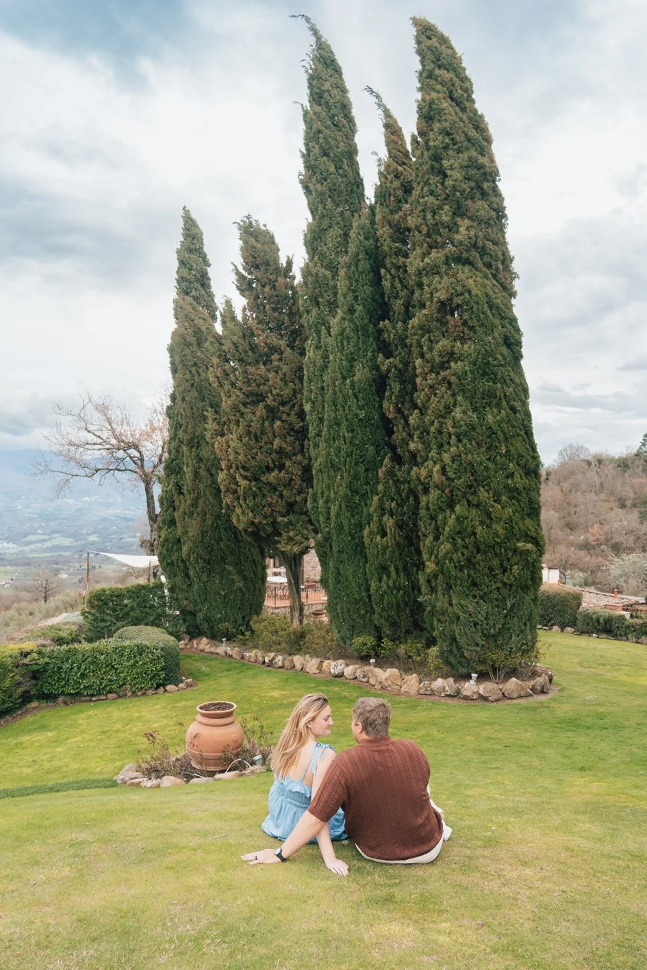 Romantic couple with cypress hills in Tuscany