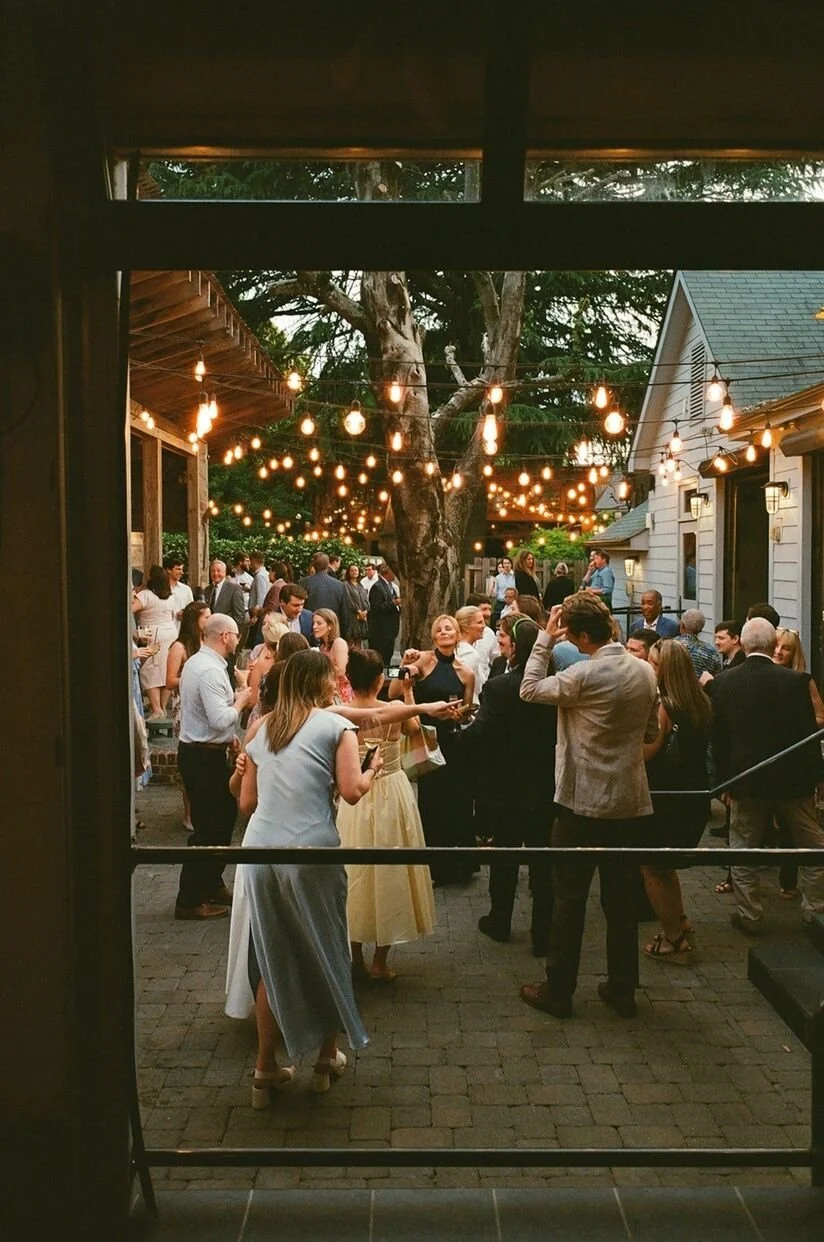 Wedding guests gathered in charming patio at The Goodyear House in Charlotte