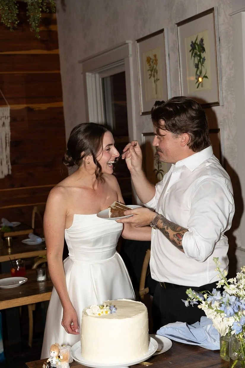 Couple cutting and eating their cake at The Goodyear House in Charlotte, NC