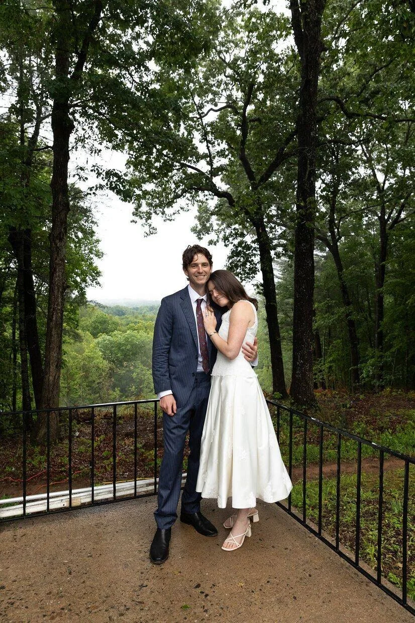 Bride and groom posing outside of groom's childhood home for their micro wedding in North Carolina