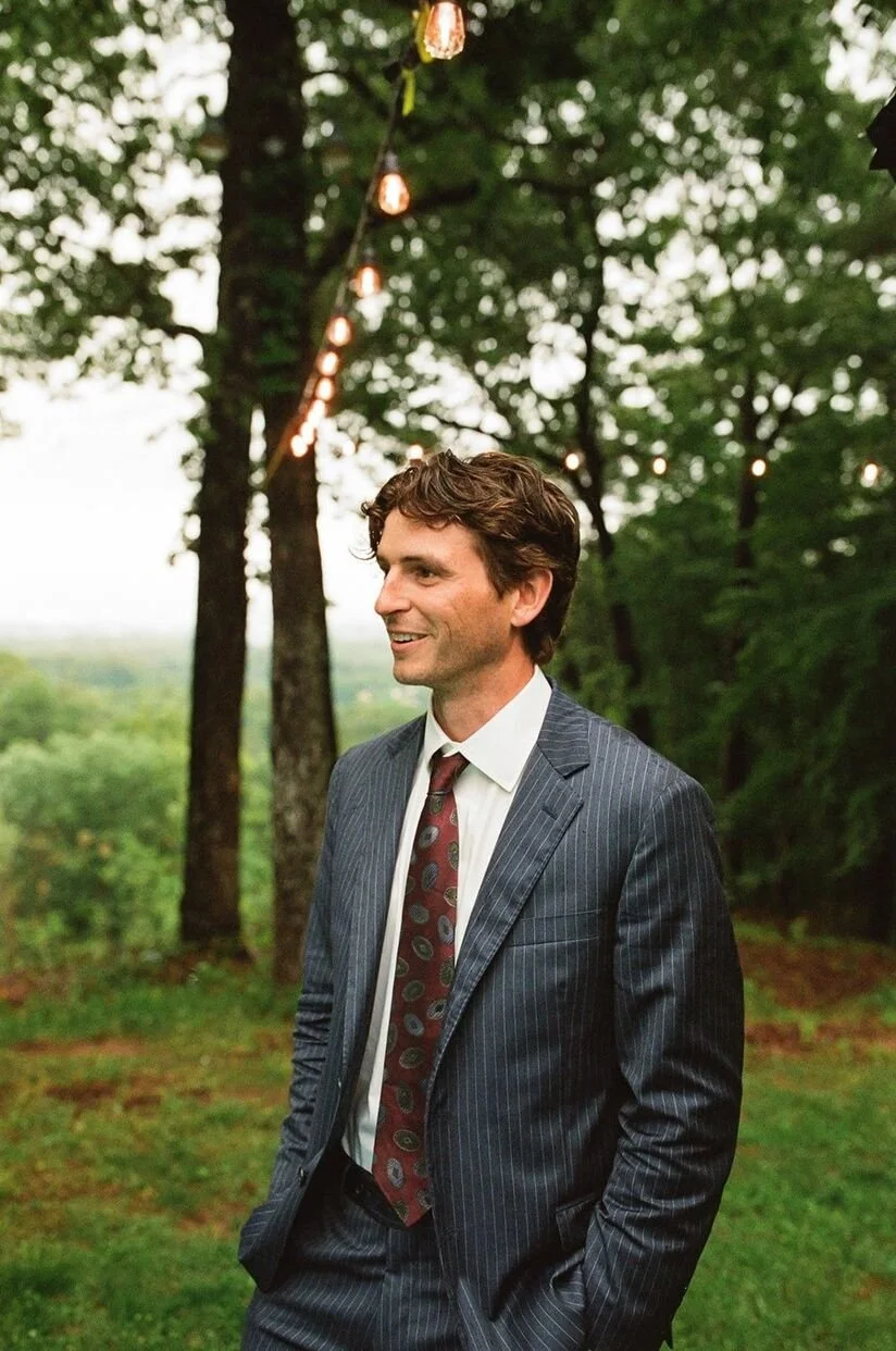 Groom ready for a micro wedding in North Carolina with trees in the background