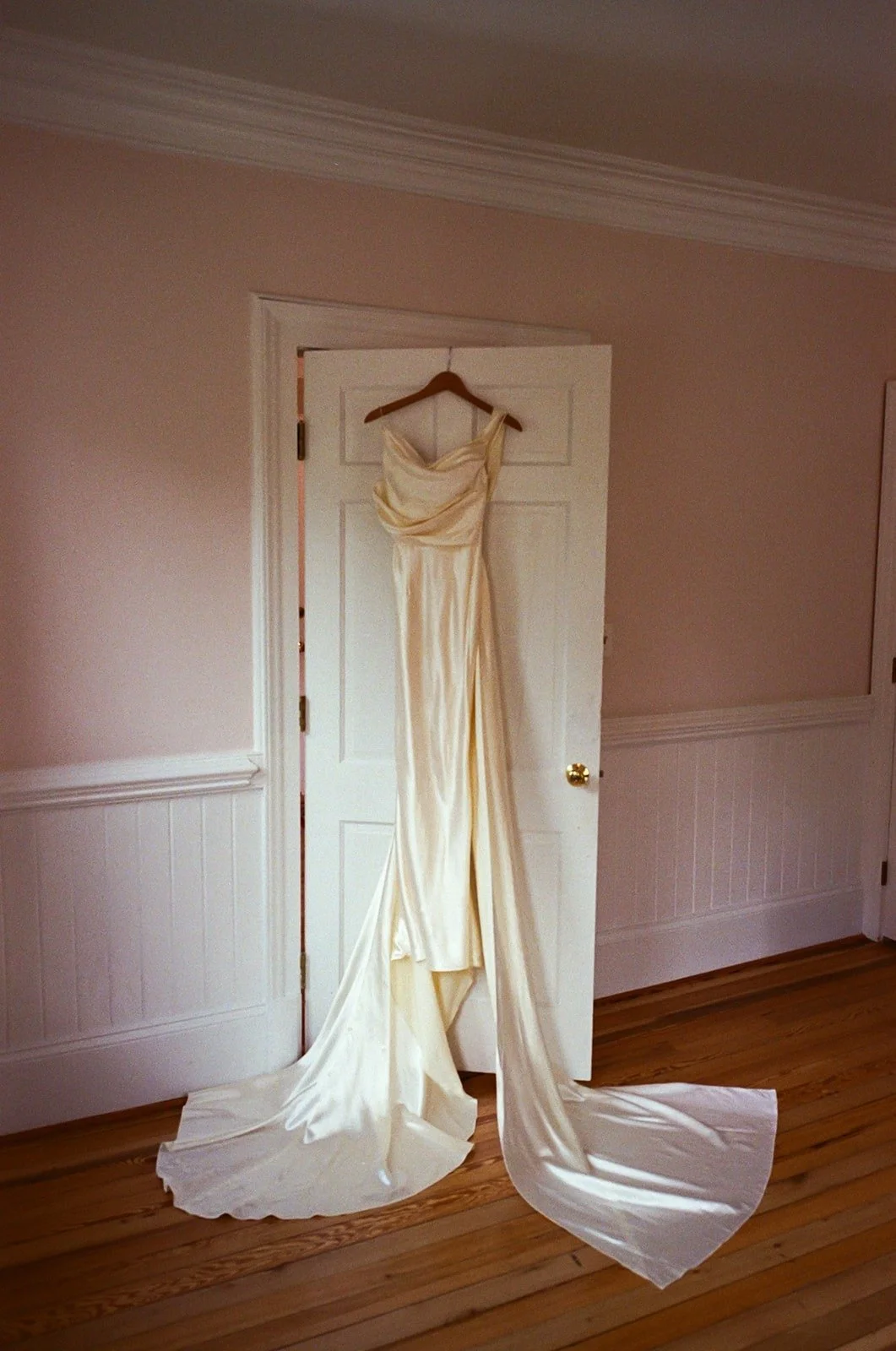 Wedding dress hanging on the back of door at The Matthews House in Cary.