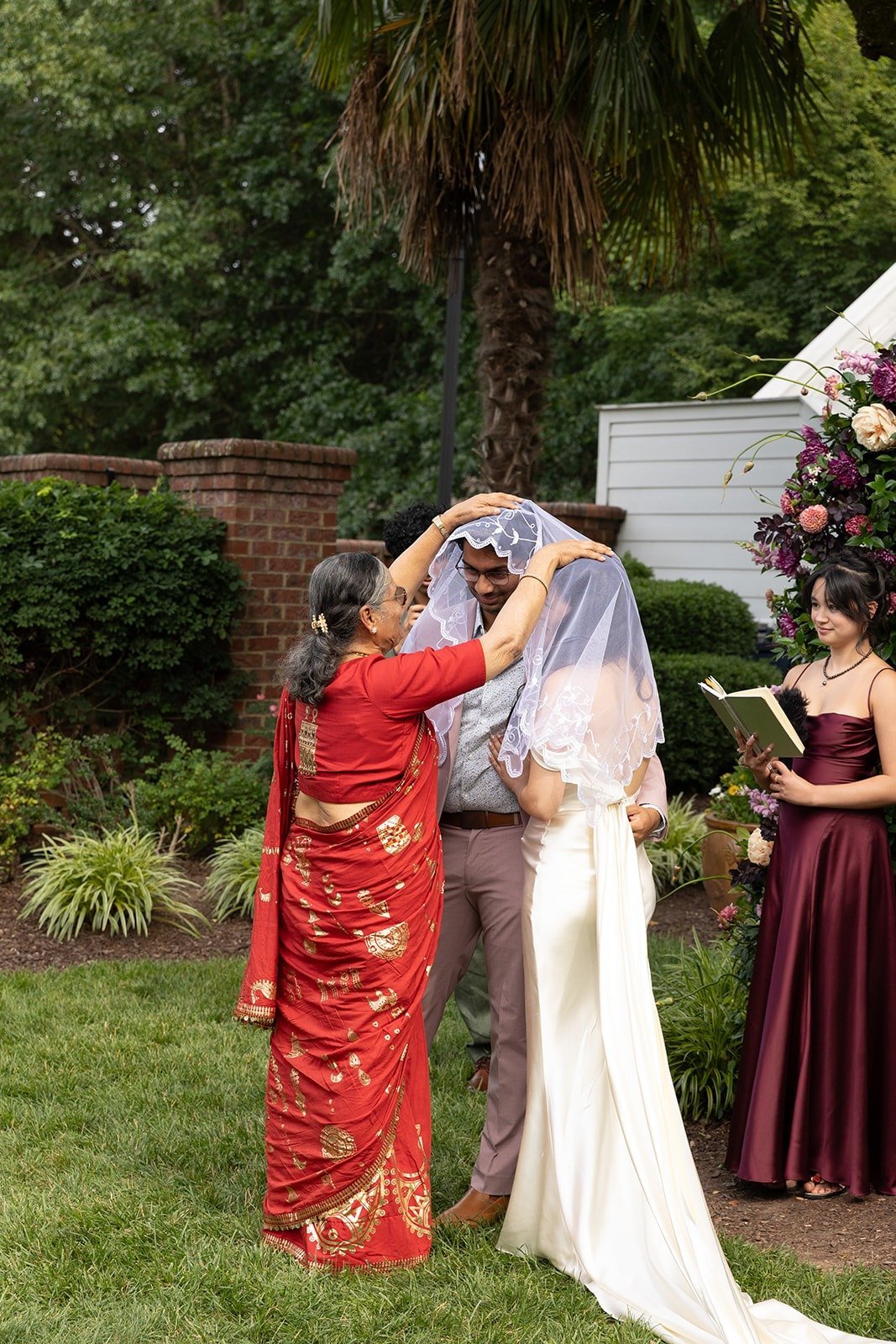 Mom giving blessing for bride and groom during ceremony at The Matthews House in Cary.