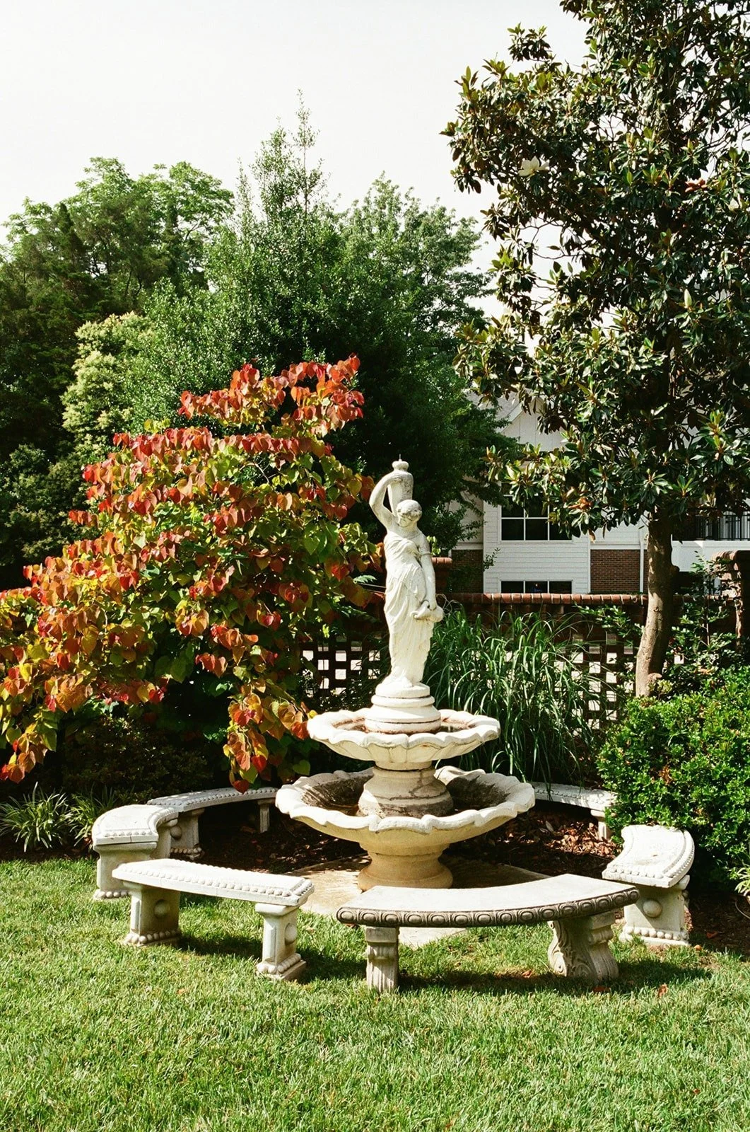 Outdoor gardens with beautiful Greek statue at The Matthews House in Cary, NC.