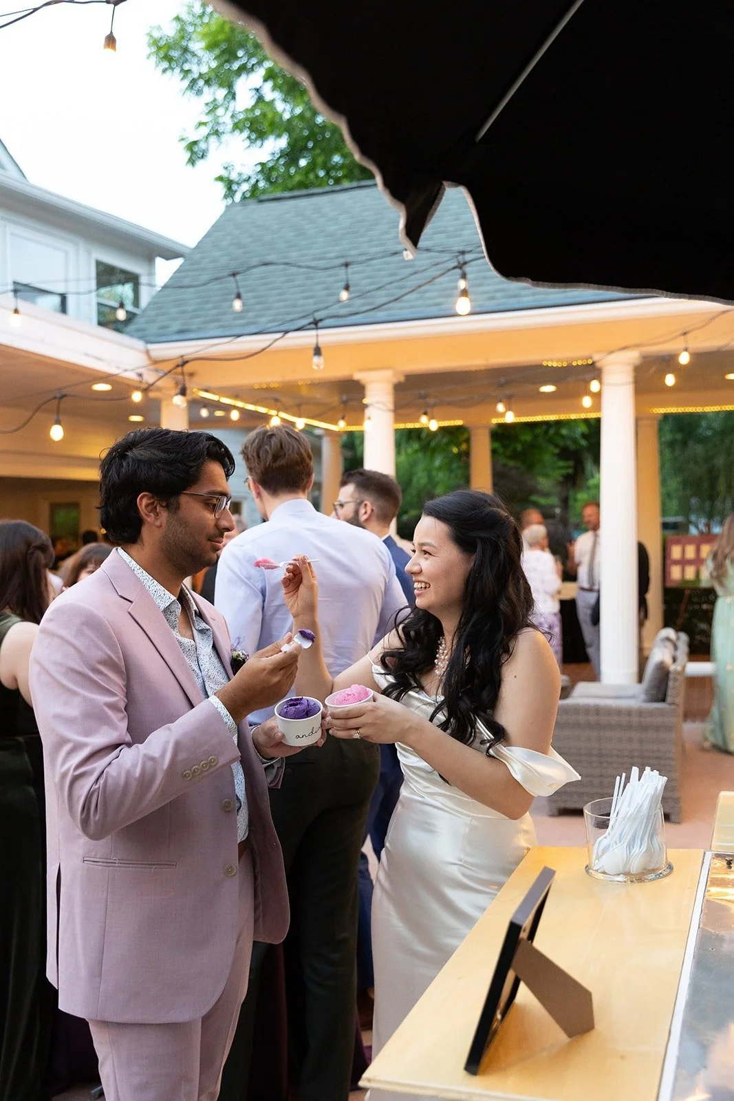 Bride and groom eating ice cream from an ice cream truck at their wedding in The Matthews House in Cary.