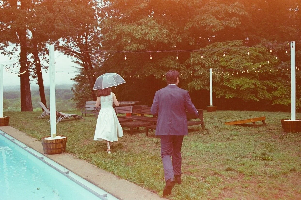 Bride and groom walking in the backyard of a home at a micro wedding in North Carolina
