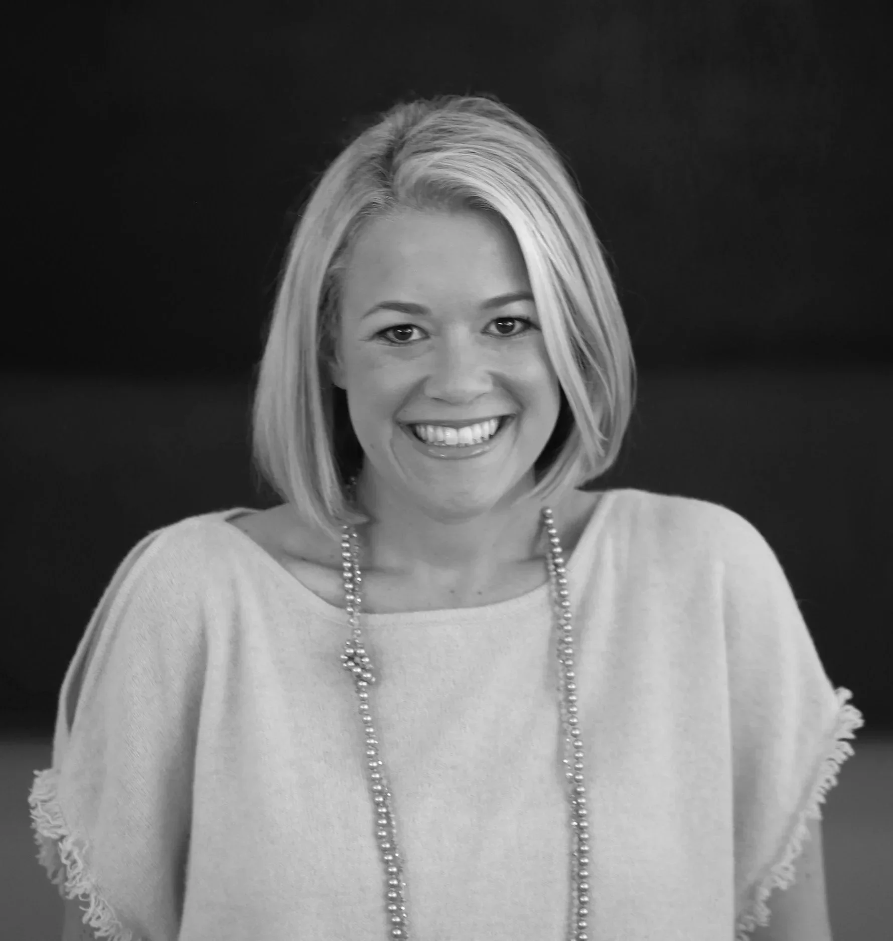 Black and white headshot of Erin smiling