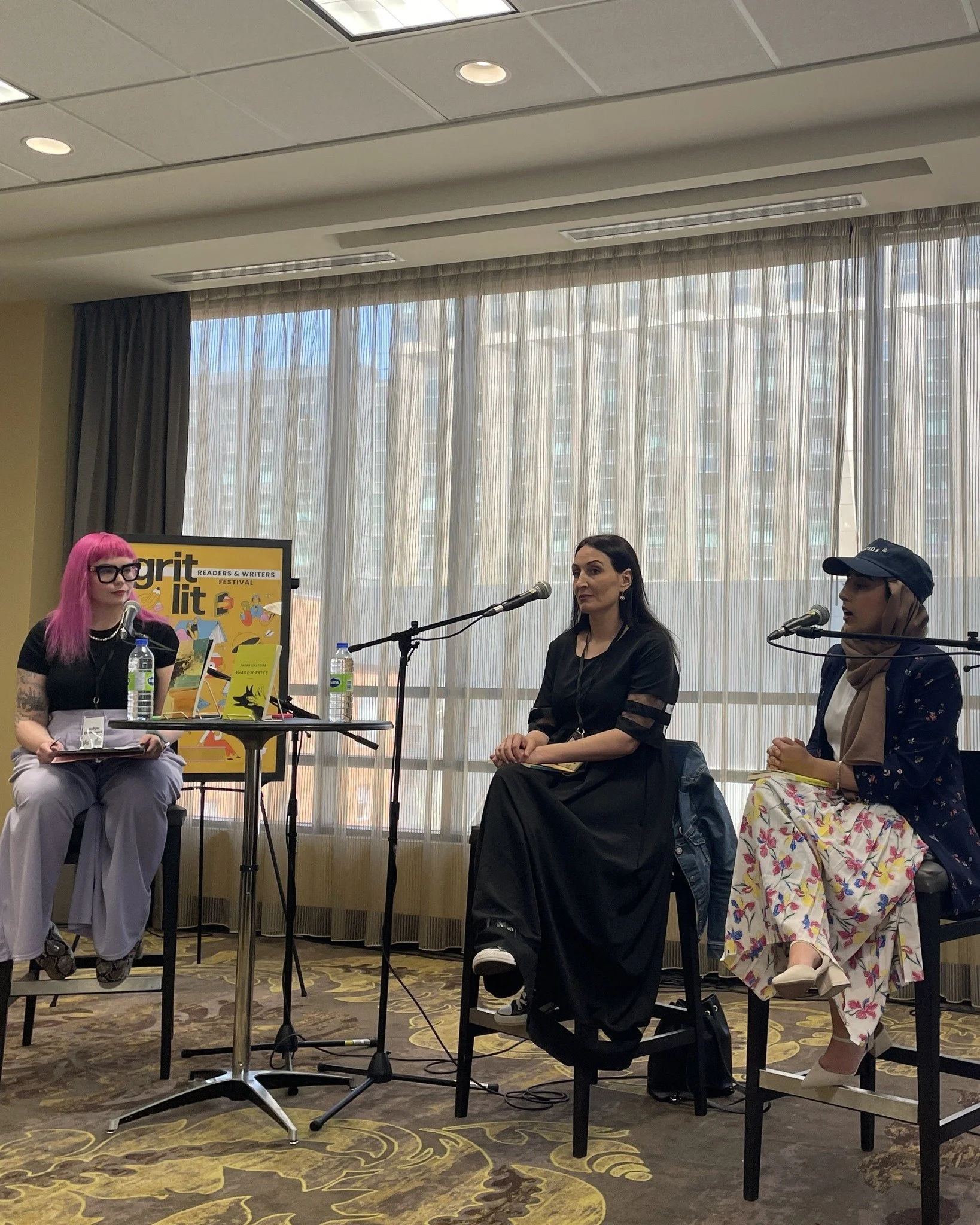A moderator sits kitty corner to two authors at Hamilton's 2025 gritLIT book festival.