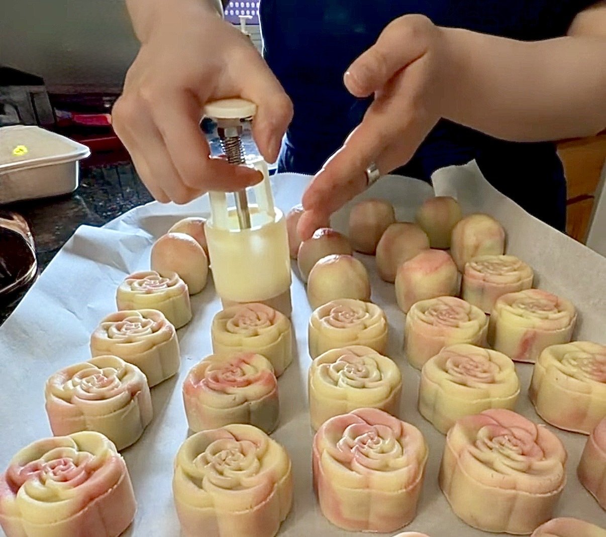 hands-pressing-mold-pink-marbled-mooncakes.jpg