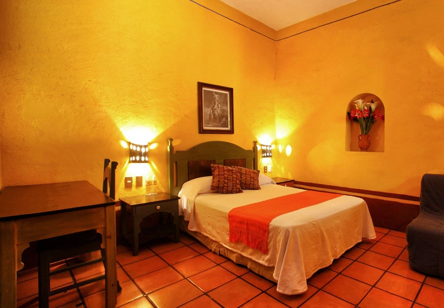 a hotel room in mexico with white covers on bed,