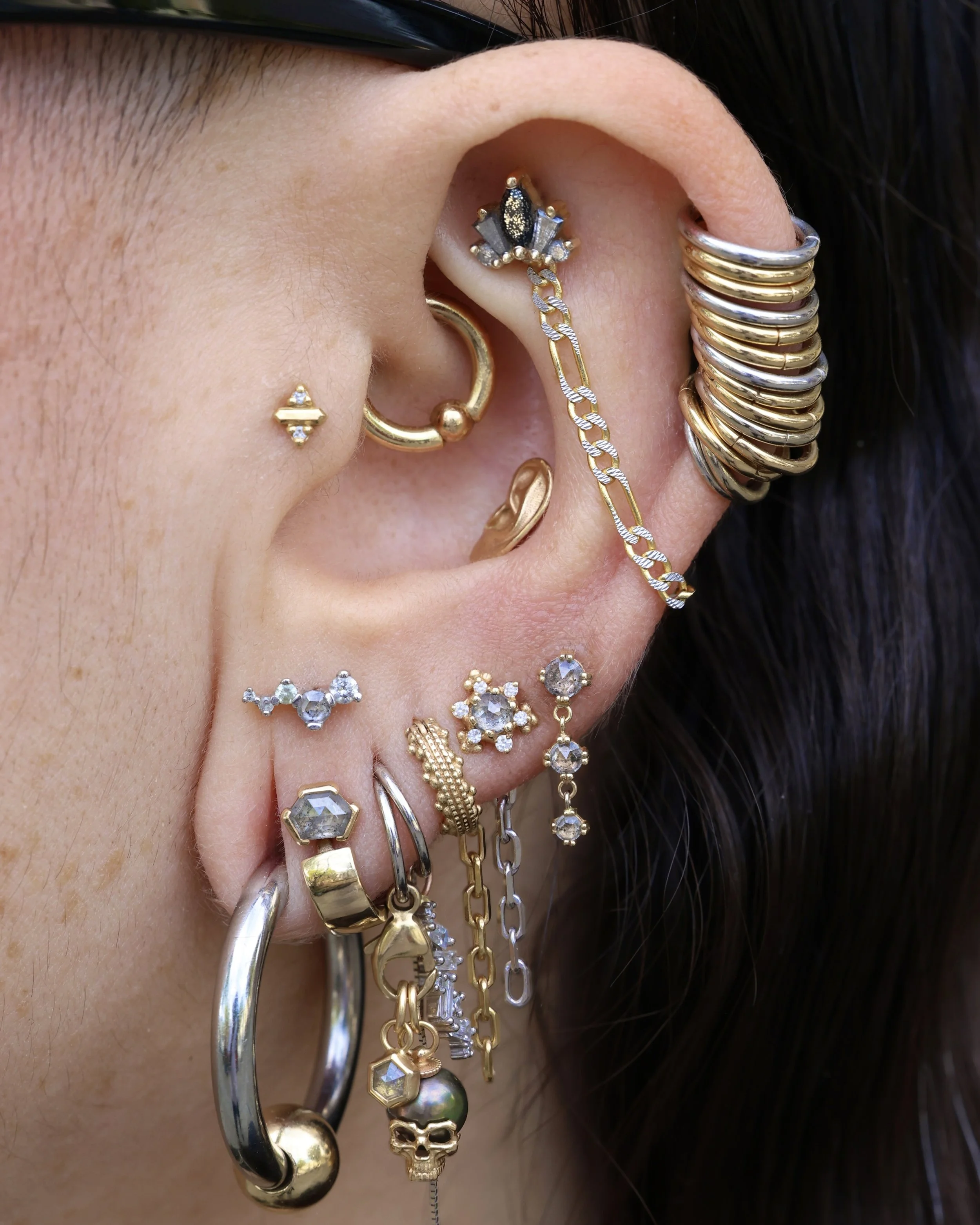 ear with lots of jewlery