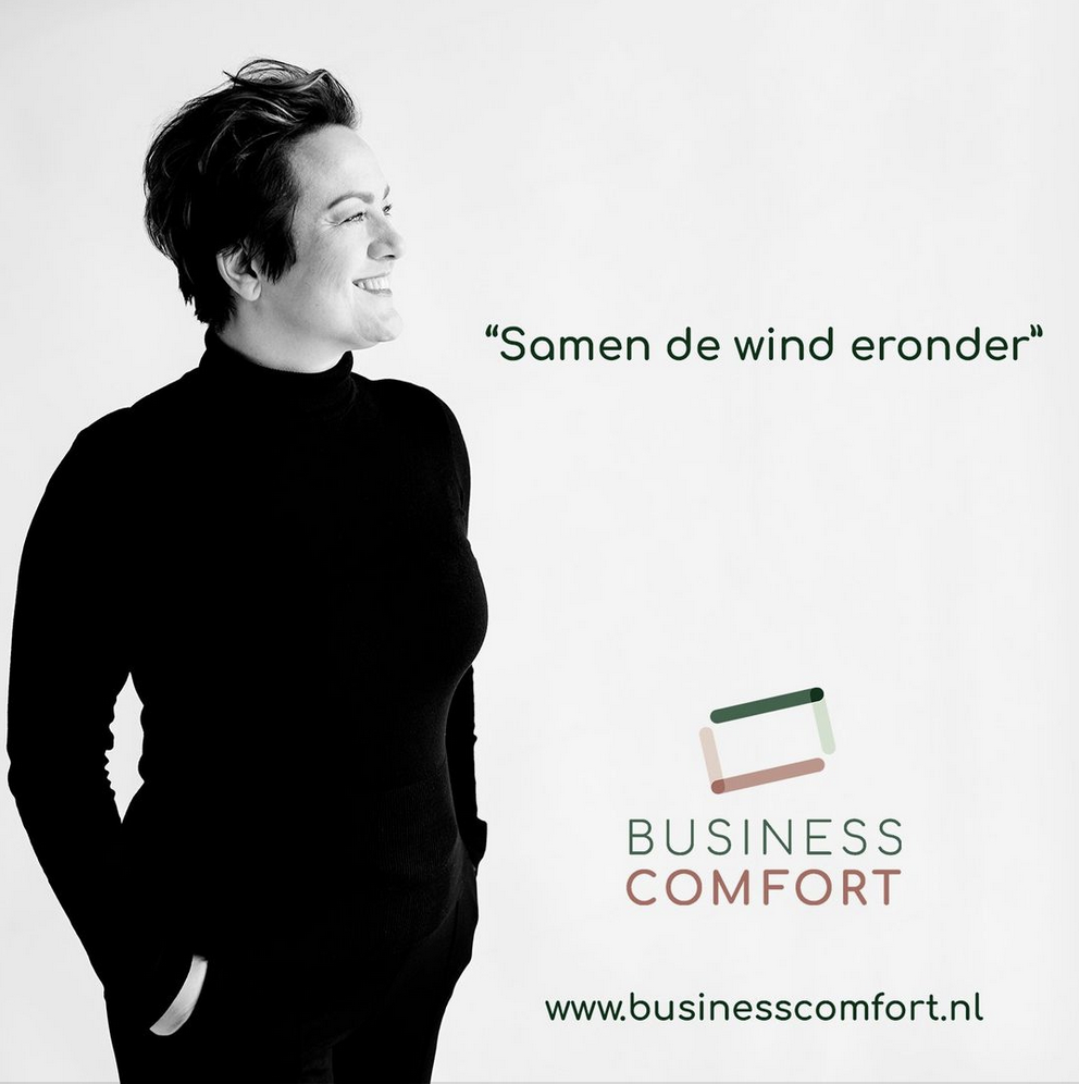 Black and white photo of a woman with short hair smiling on a white background, with text and logo for Business Comfort and a website link.