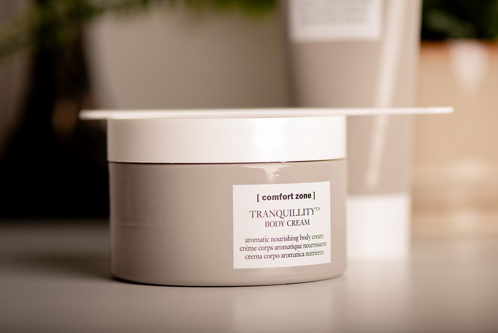 A round jar of Tranquillity Body Cream on a white surface with a white lid and a label on the front.